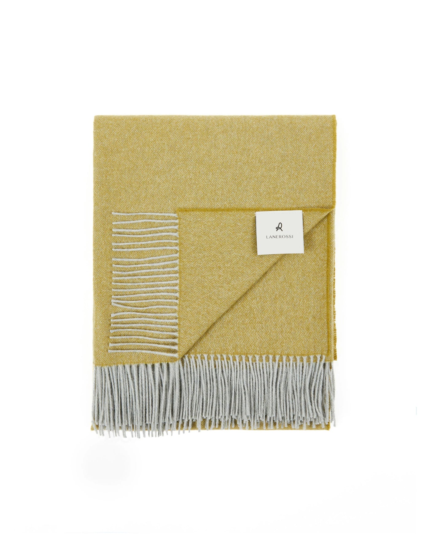 Cassiopea throw folded, mustard yellow with grey fringe and white embroidered stripe detail.