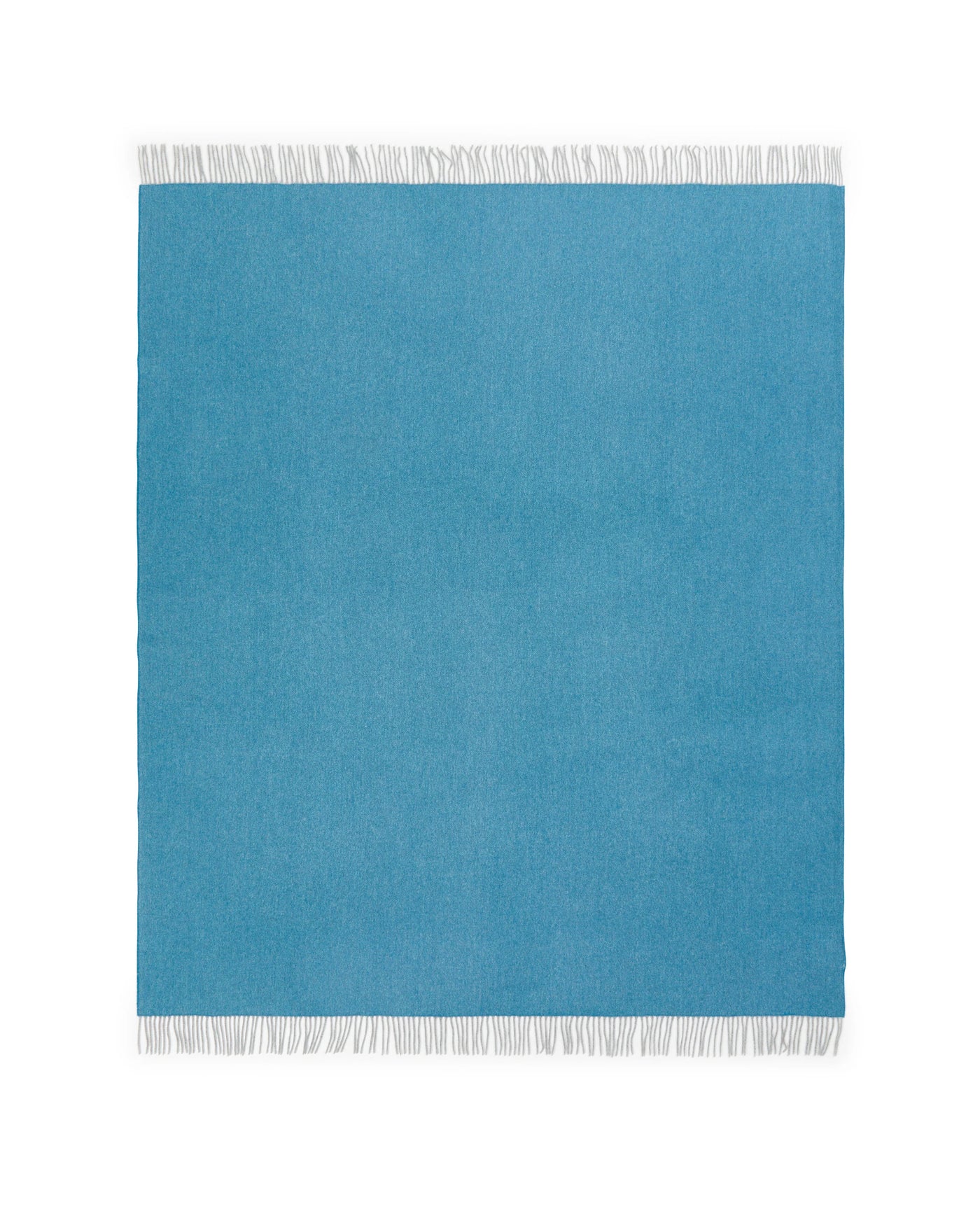 Lanerossi Cassiopea throw in ocean blue with white fringe trim, flat lay view.
