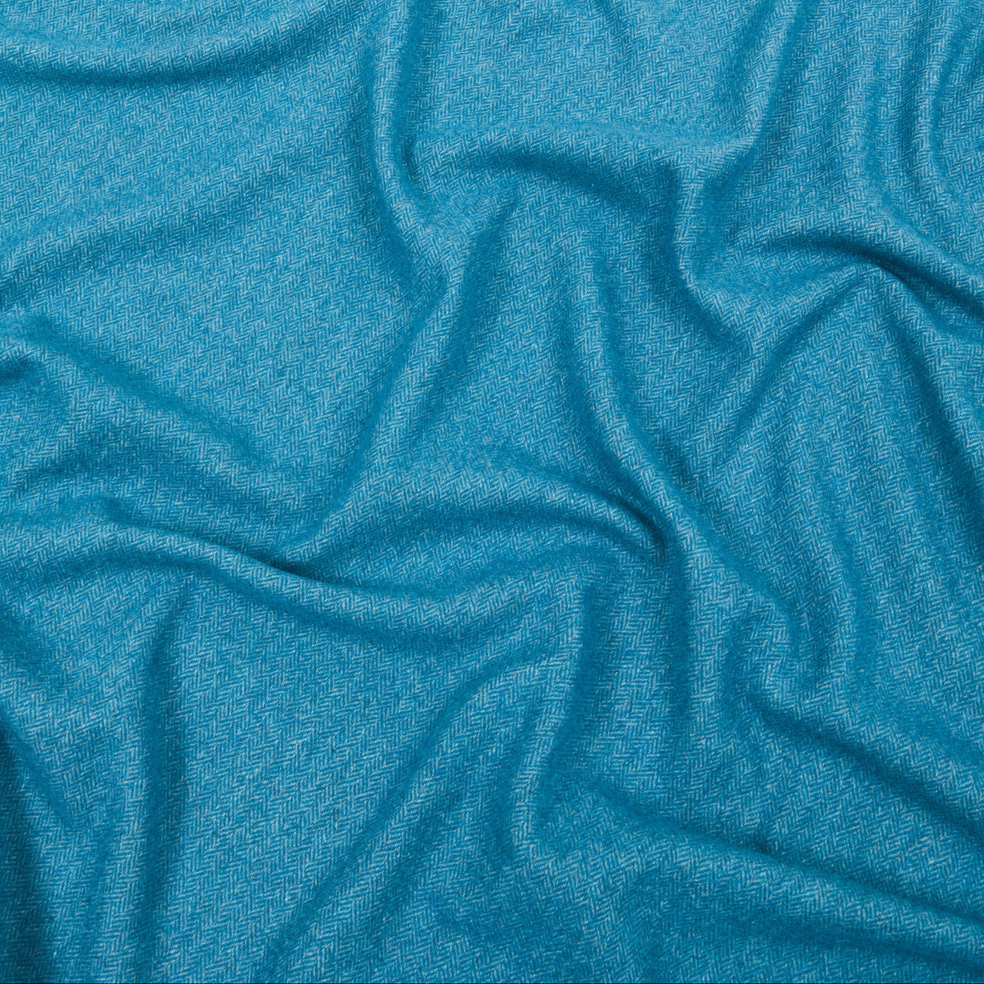 Close-up of draped teal Lanerossi Cassiopea throw, showing soft heathered cashmere texture.