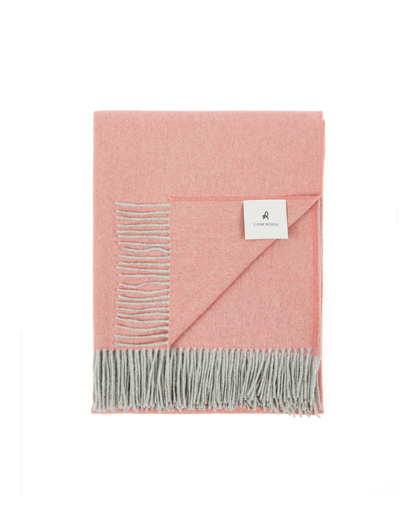 Folded blush throw with grey fringe trim and tonal embroidered detail, corner turned to show reverse.