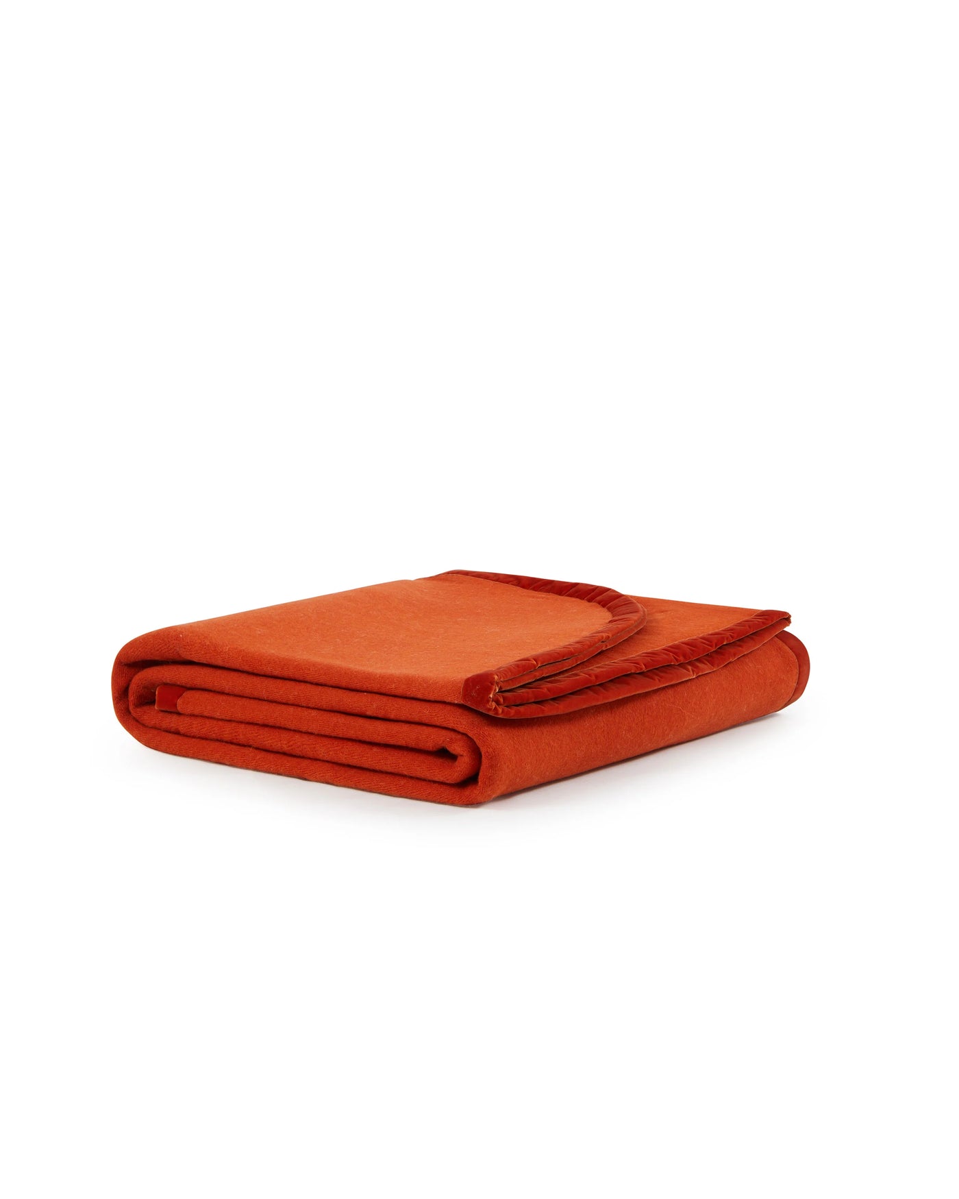 Lanerossi Color thermo blanket folded, showing fringe trim edge in rust orange.