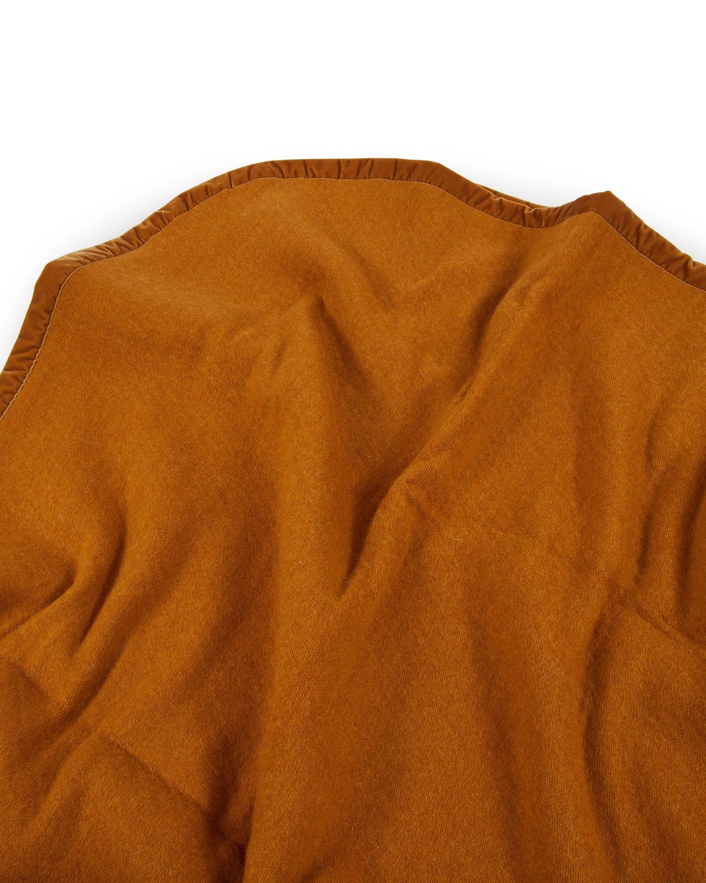 Close-up of Lanerossi Thermo Blanket in amber, showing soft wool texture and finished edge.