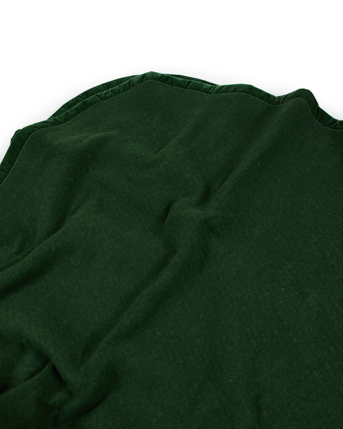 Close-up of forest green Lanerossi Thermo Blanket hem with scalloped trim detail.