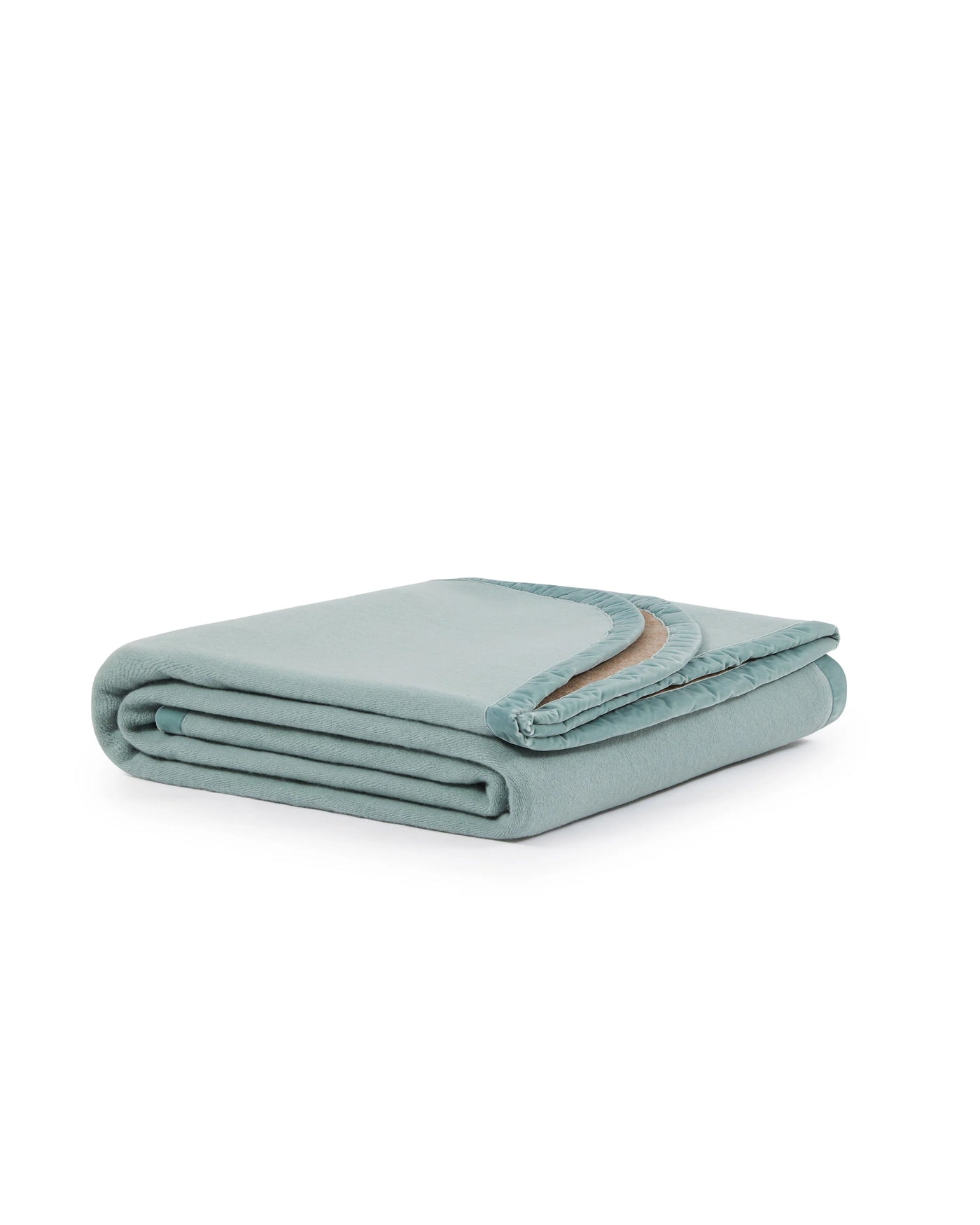 Folded sage green blanket with a contrasting camel trim detail visible at corner.