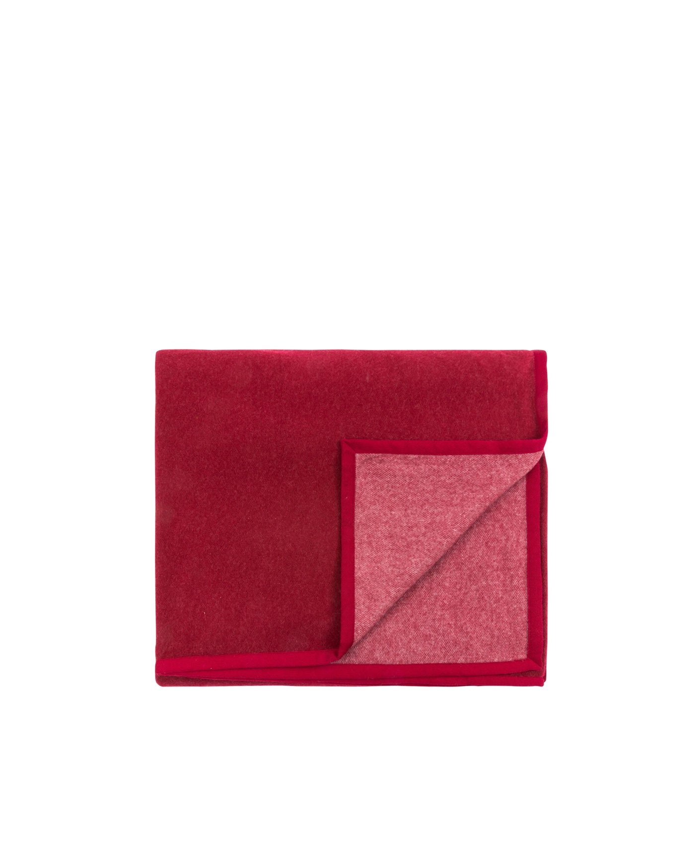 Corner fold detail revealing rose-pink reverse on Cortina crimson blanket.