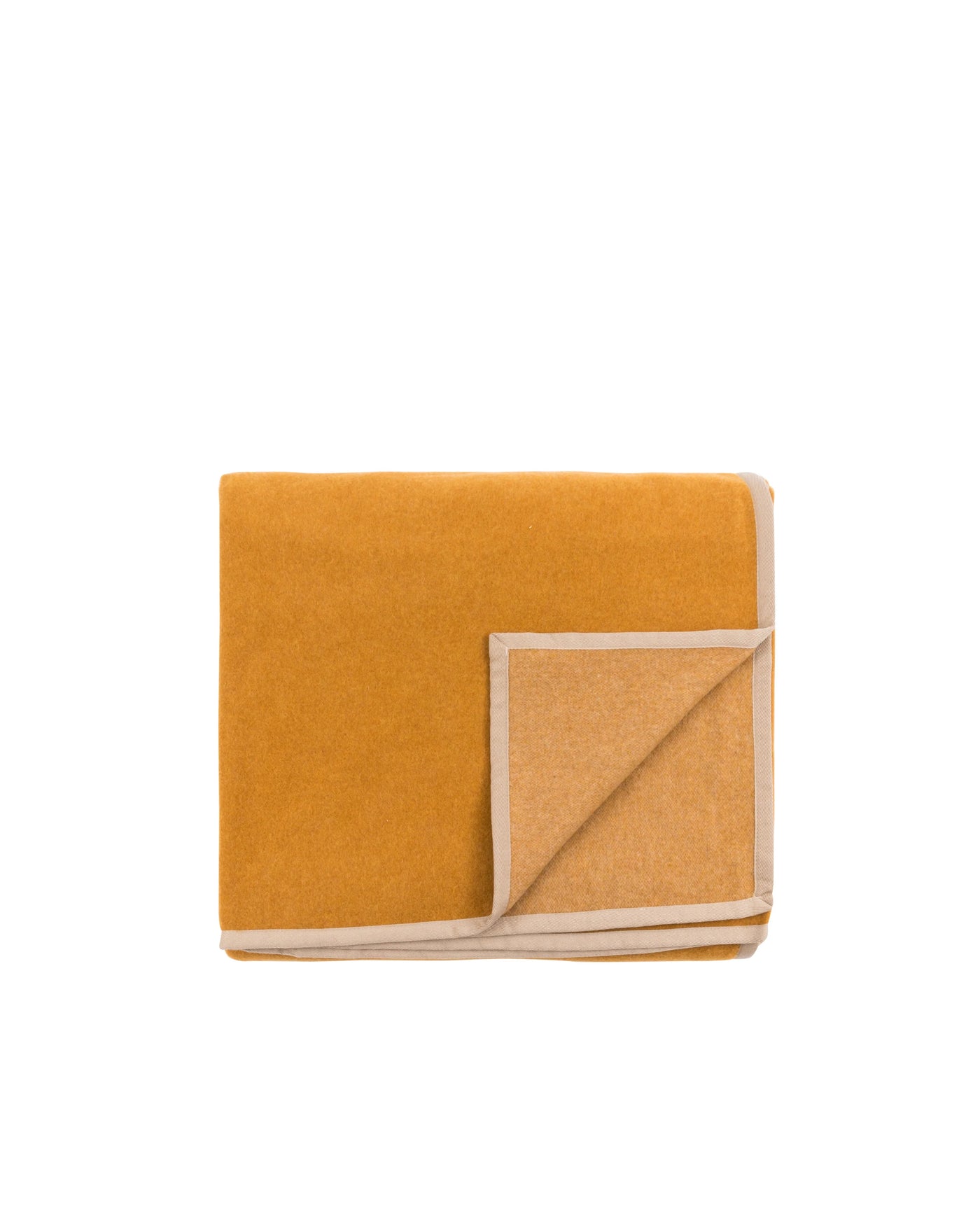 Folded blanket corner detail revealing saffron and camel reversible wool weave.