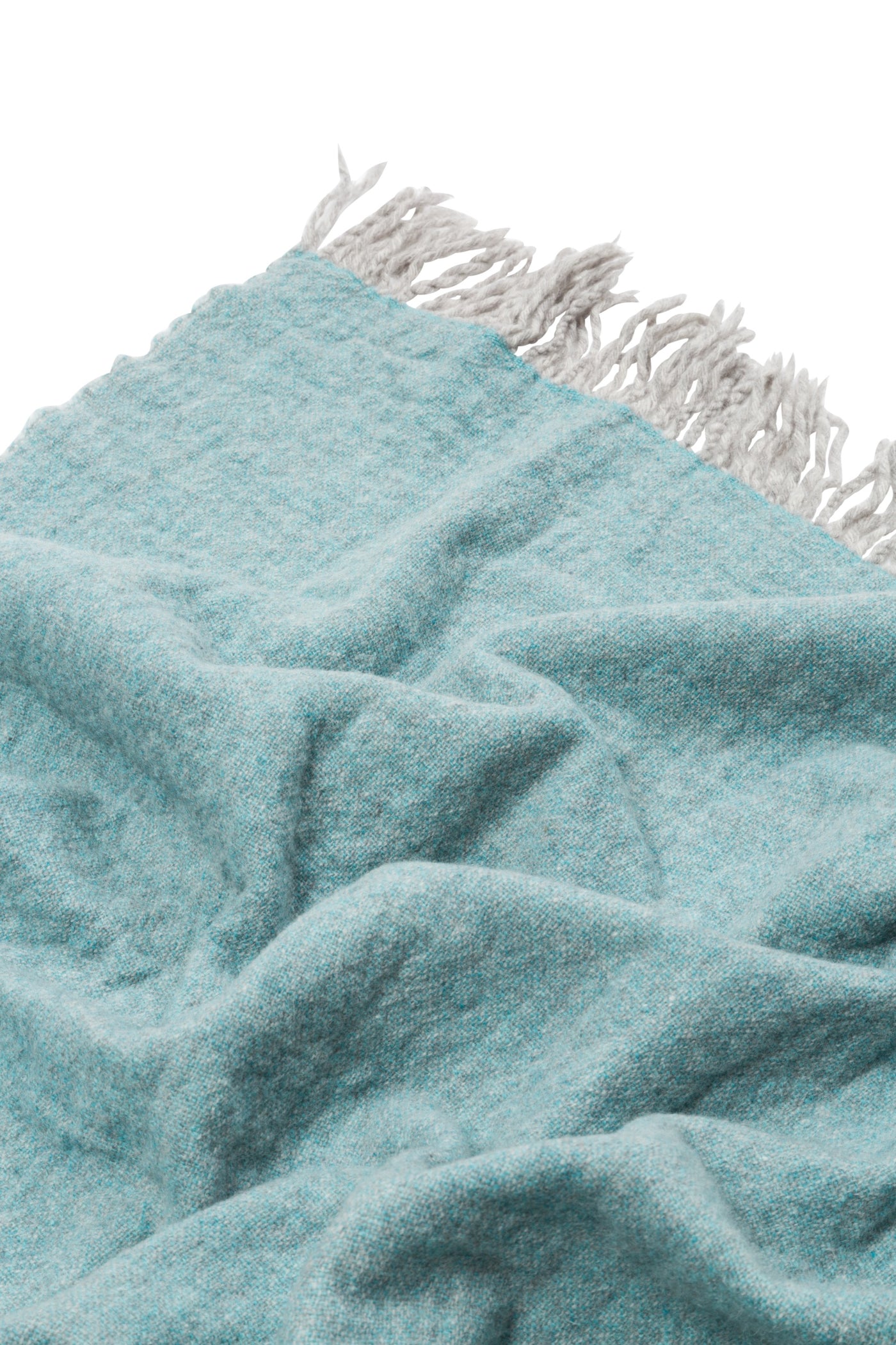 Close-up of Lanerossi Dioniso throw in aqua, showing boucle texture and knotted fringe edge.