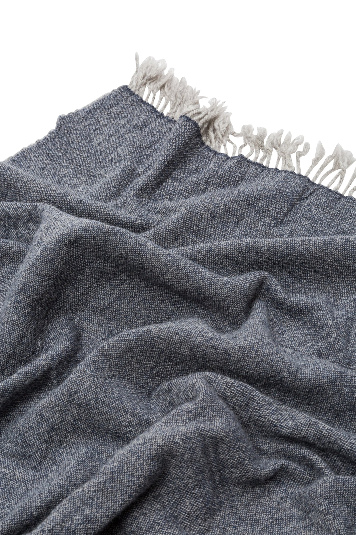 Close-up of draped charcoal Lanerossi Dioniso throw with ivory fringe trim.