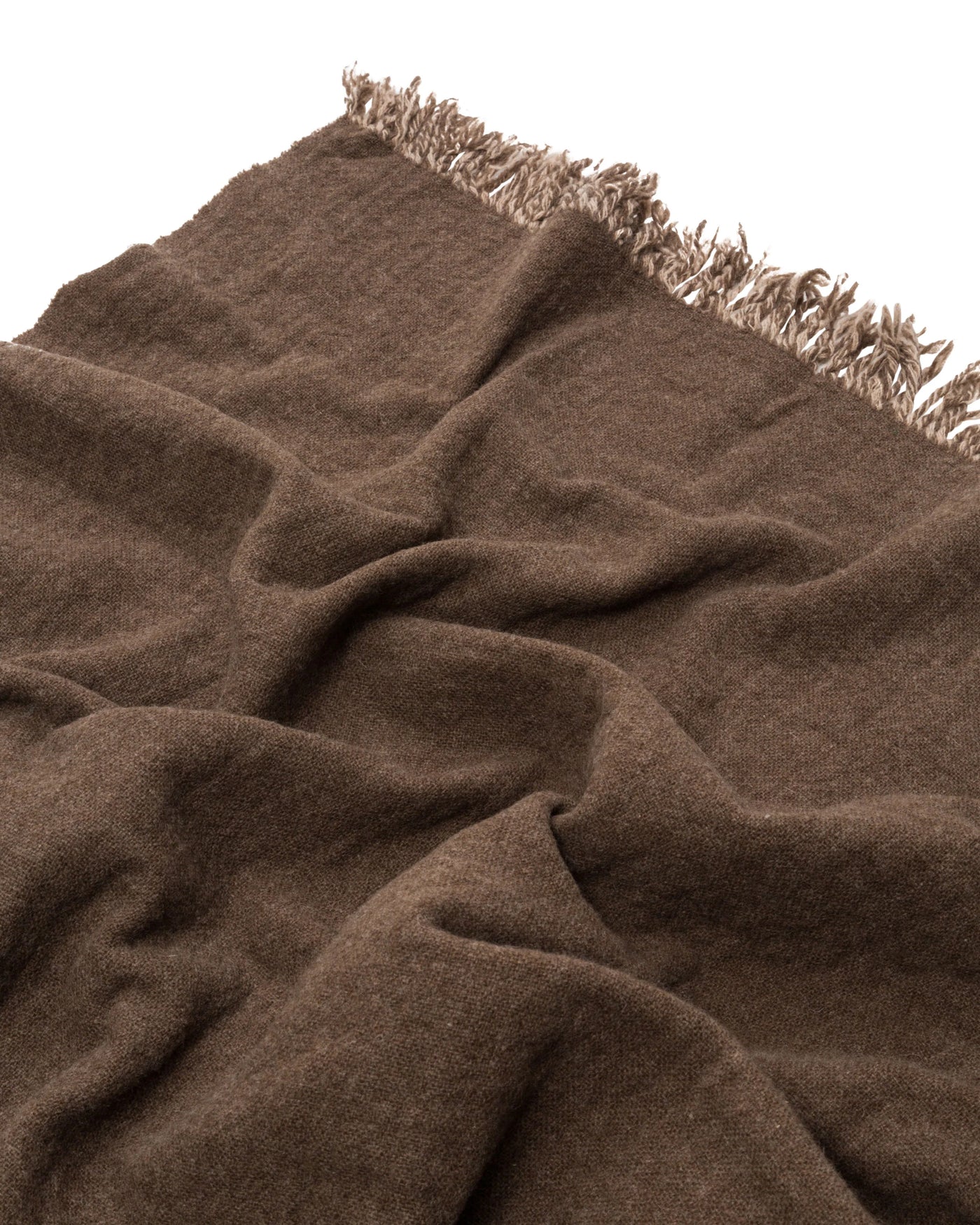 Close-up of Lanerossi Dioniso throw in chocolate brown with fringe trim detail.