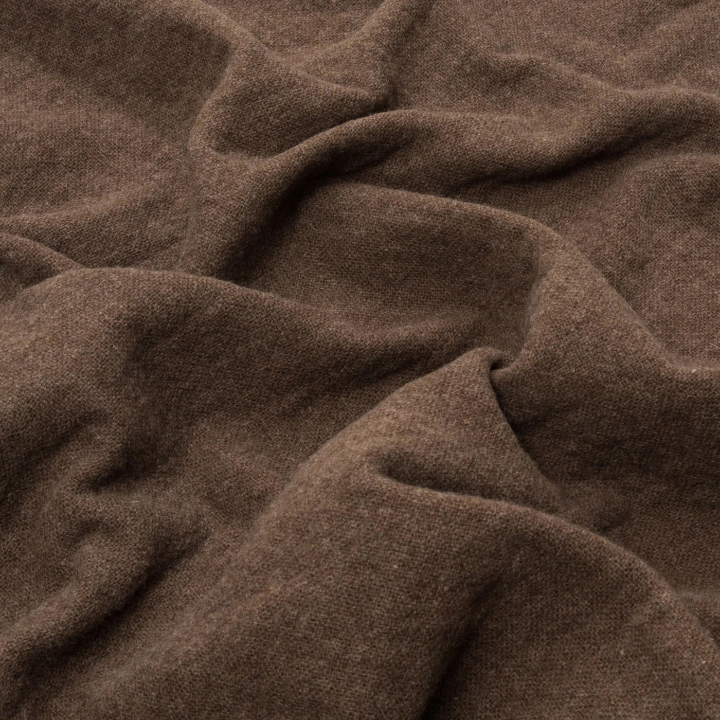 Close-up of Lanerossi Dioniso throw in warm chestnut, showing soft draped wool texture.