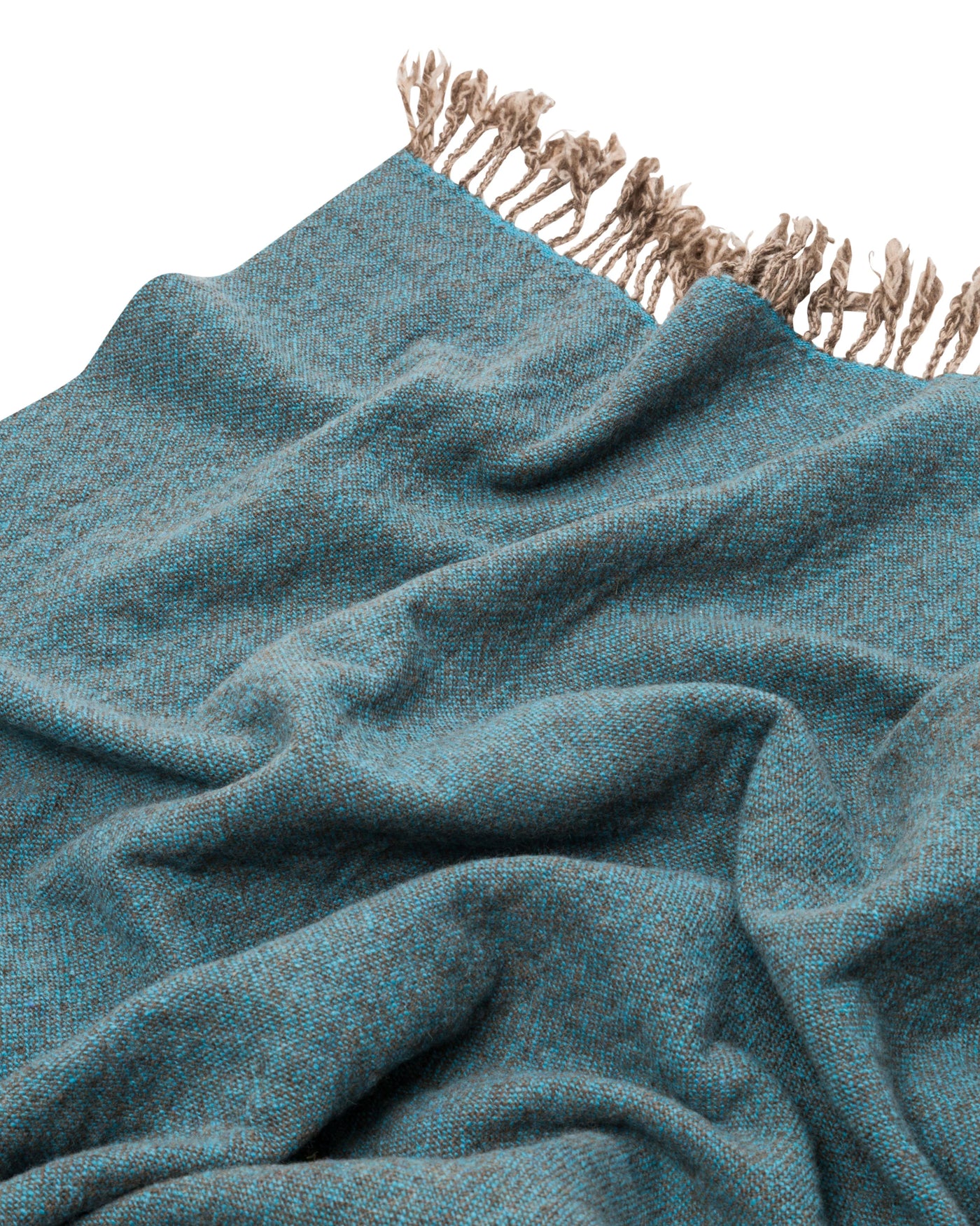 Close-up of draped teal Lanerossi Dioniso throw showing flecked weave texture and natural fringe trim.