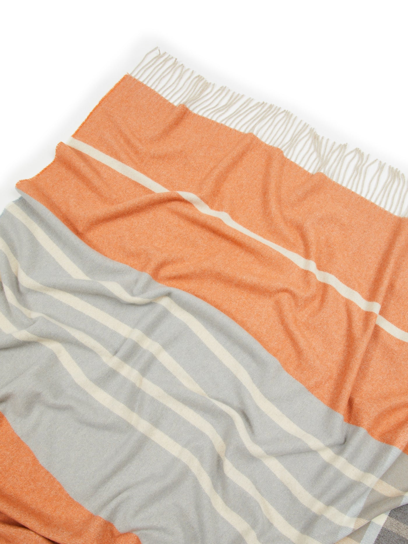 Close-up of Lanerossi Everest throw in tangerine and silver stripes with ivory fringe trim.
