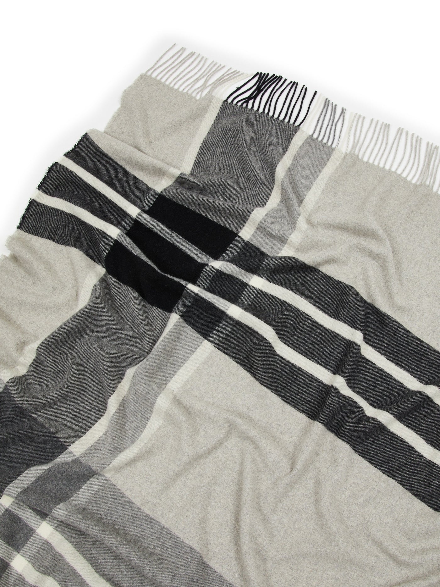 Close-up of Lanerossi Everest Check throw fringe edge, ivory and charcoal plaid weave.
