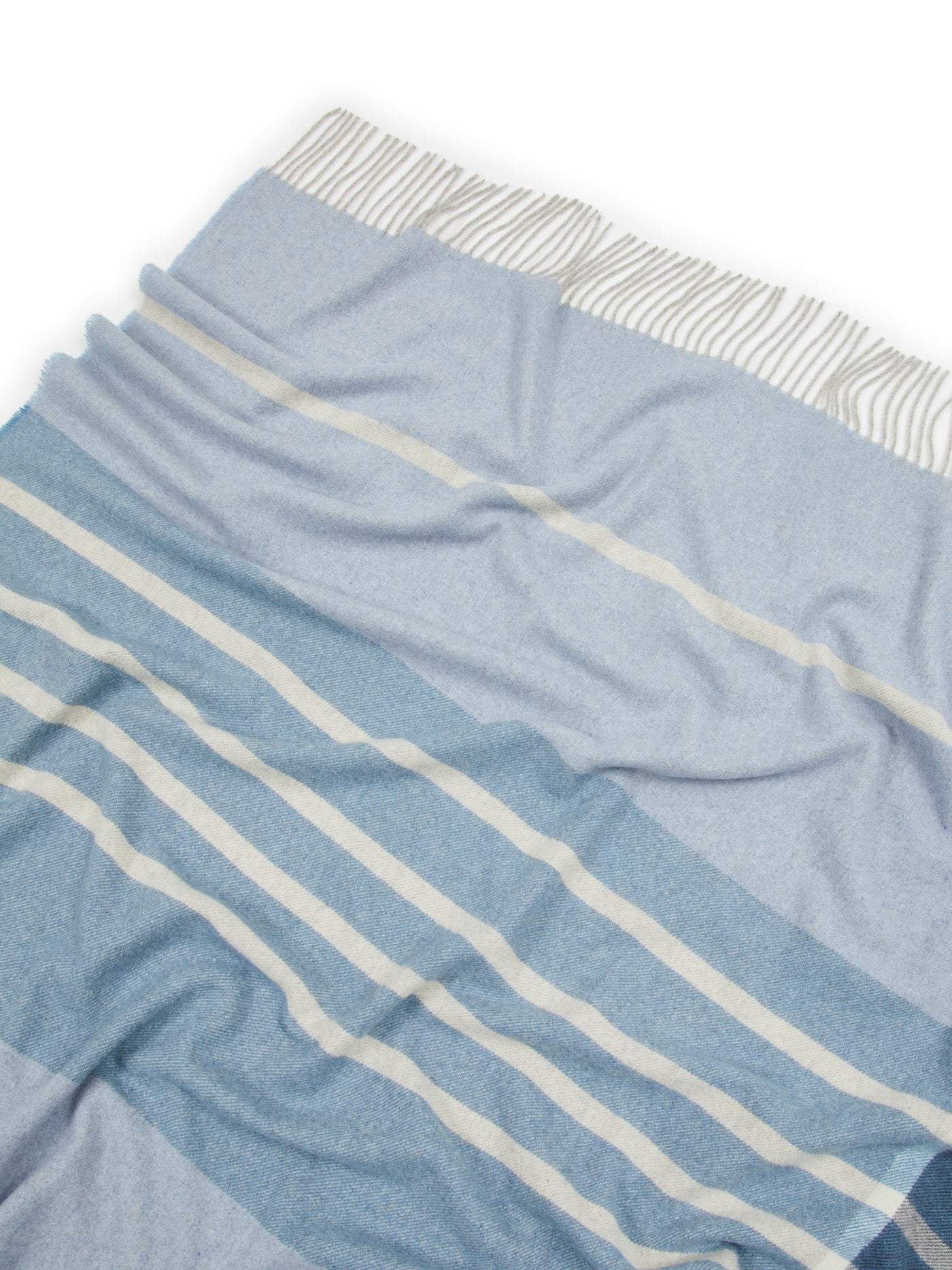 Close-up of Lanerossi Everest throw in blue with ivory stripes and woven fringe hem.