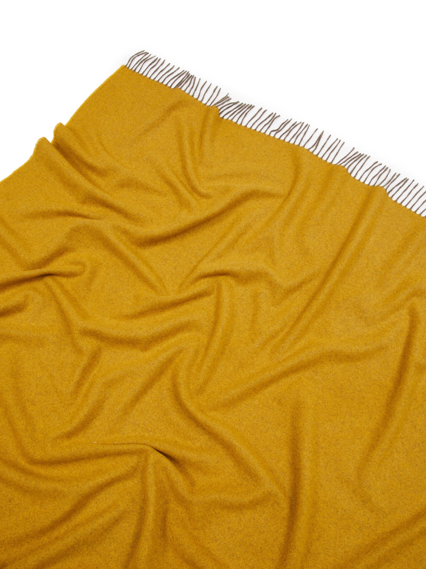 Close-up of saffron Lanerossi Everest Colour throw with striped fringe detail.
