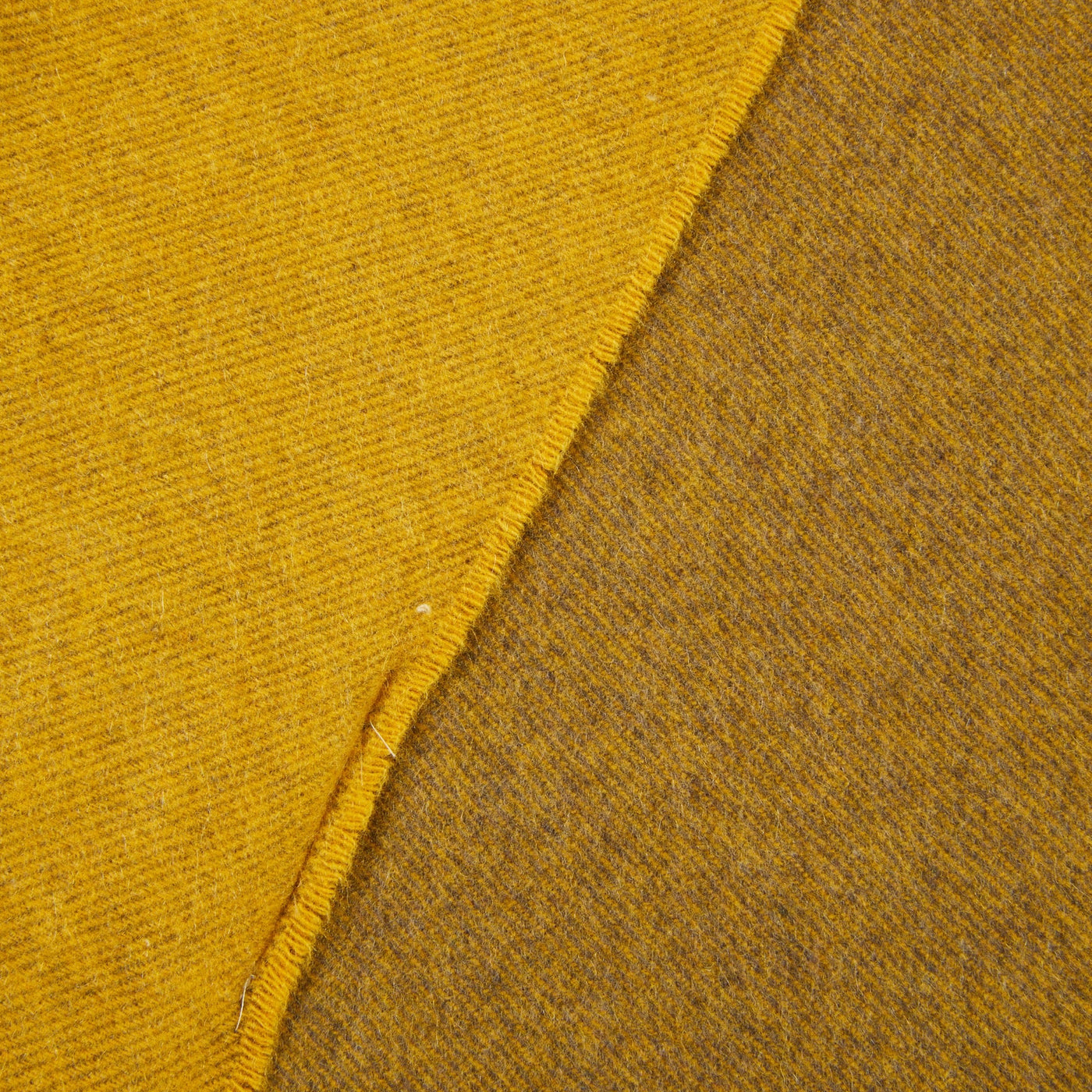 Close-up of Lanerossi Everest Colour throw edge showing contrast between saffron face and olive reverse.