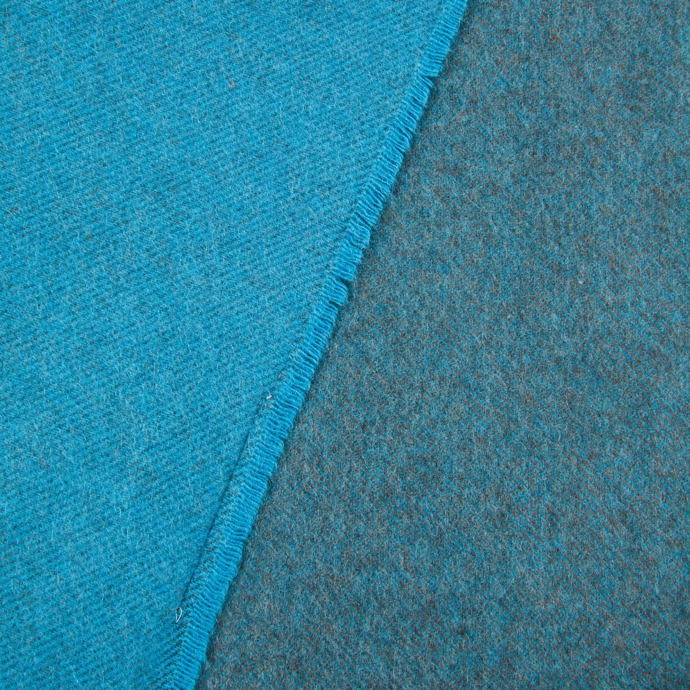 Close-up of Lanerossi Everest Colour throw hem, showing turquoise face and slate reverse.