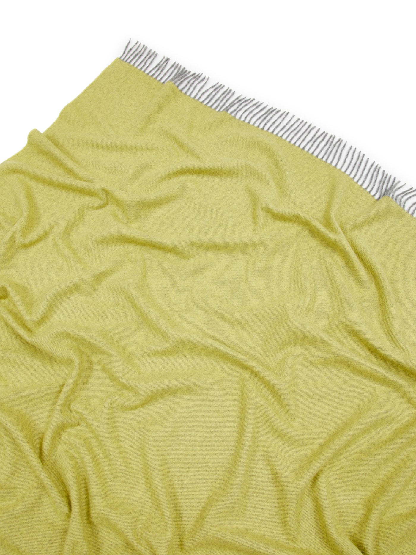 Lanerossi Everest Colour throw in chartreuse, draped flat showing striped fringe trim.