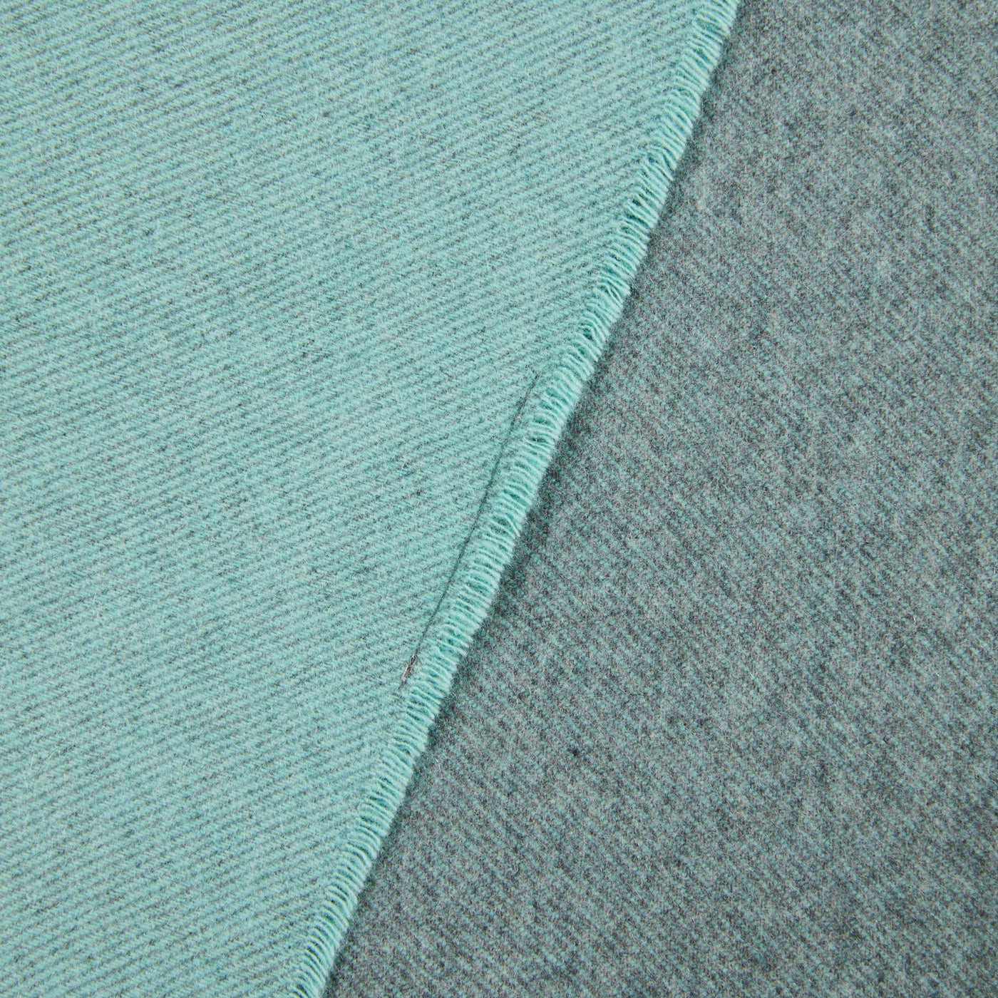 Close-up of Lanerossi Everest Colour throw corner, showing aqua and grey reversible wool weave.