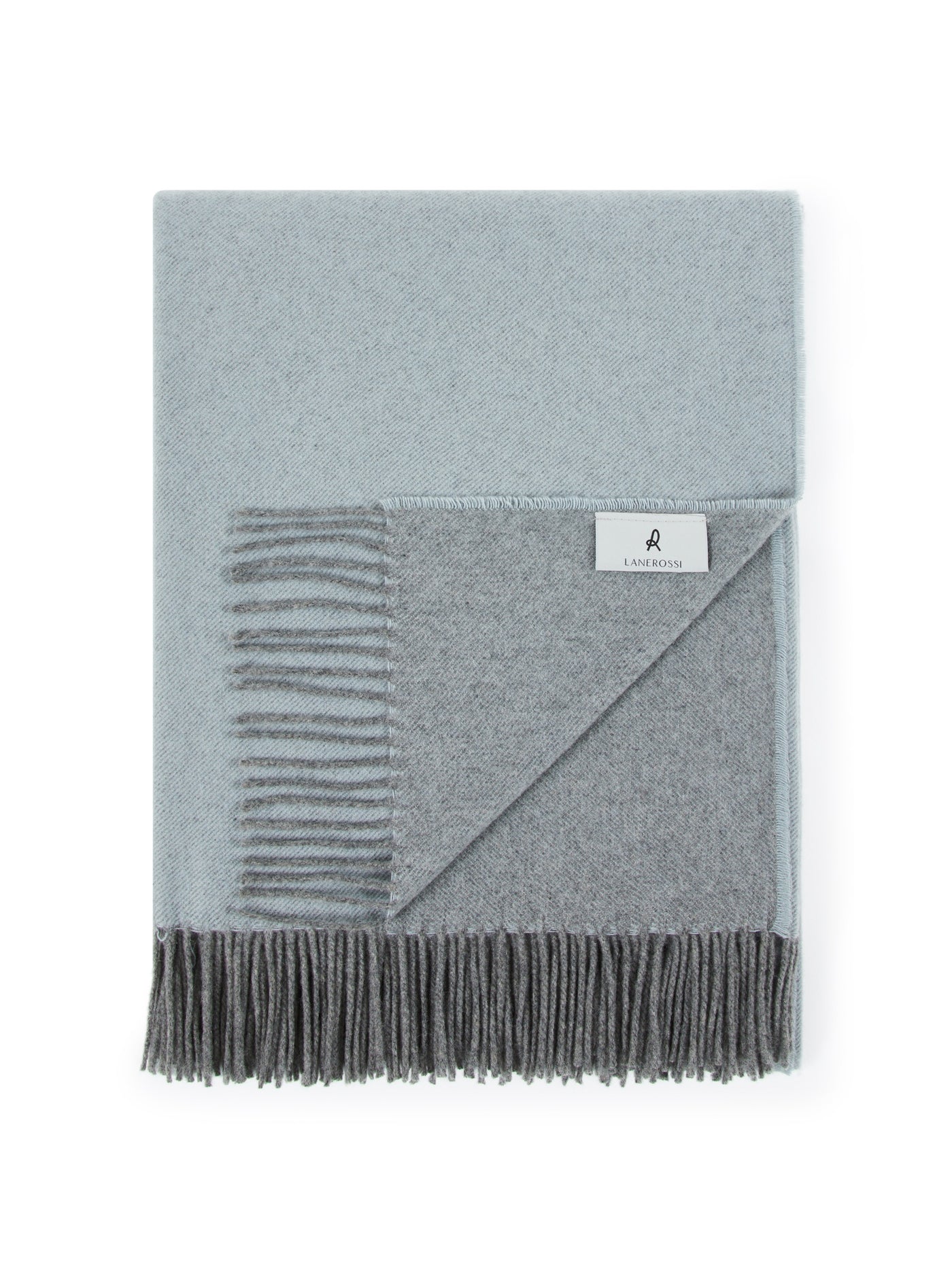 Folded Lanerossi Everest Colour throw, pale blue and charcoal grey reversible with fringed hem.
