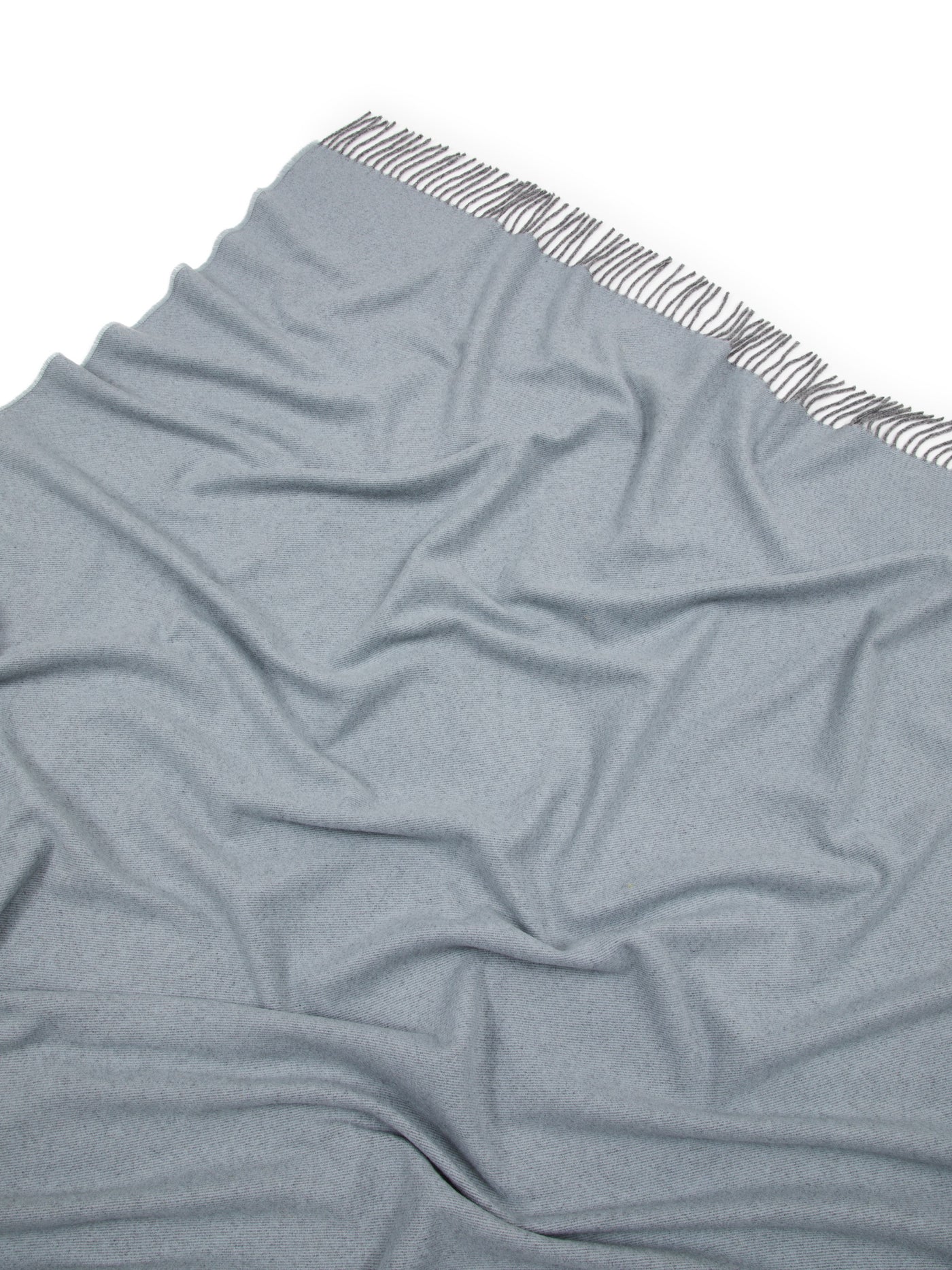 Close-up of Lanerossi Everest Colour throw in slate blue with fringe trim detail.