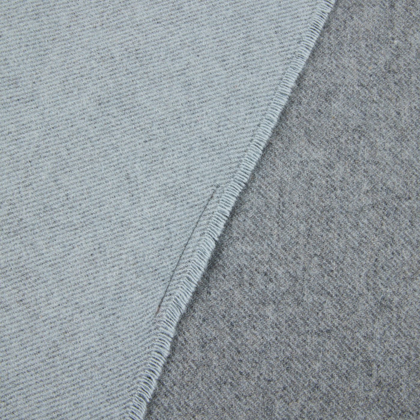 Close-up of Lanerossi Everest Colour throw corner showing pale blue and grey reverse sides with blanket-stitched edge.