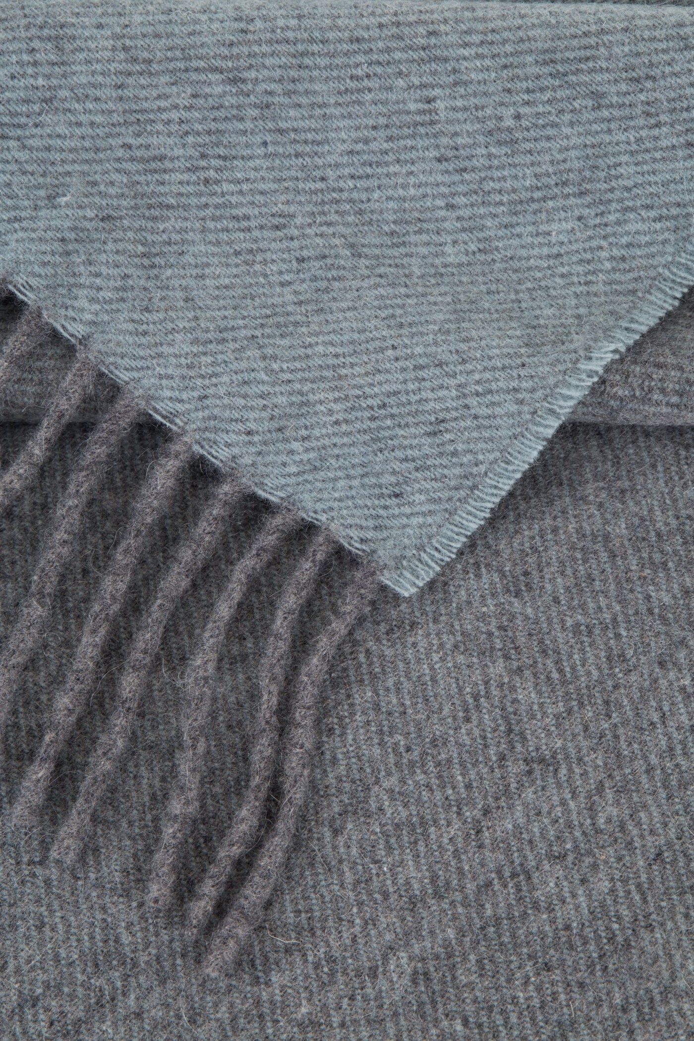Corner fold detail revealing slate reverse and fringe on Lanerossi Everest Colour throw.