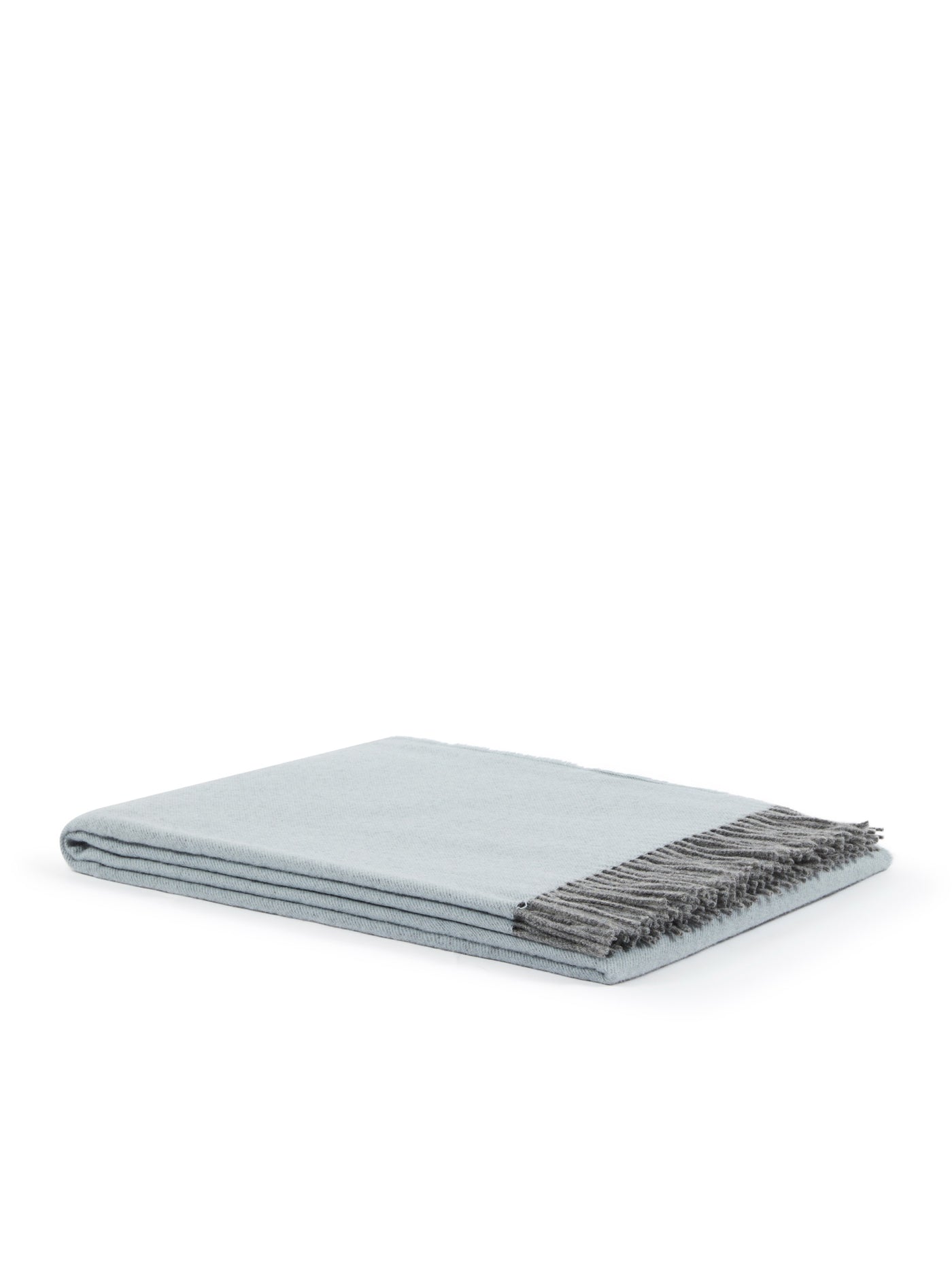 Folded duck-egg blue throw with contrasting charcoal fringe trim, side angle view.