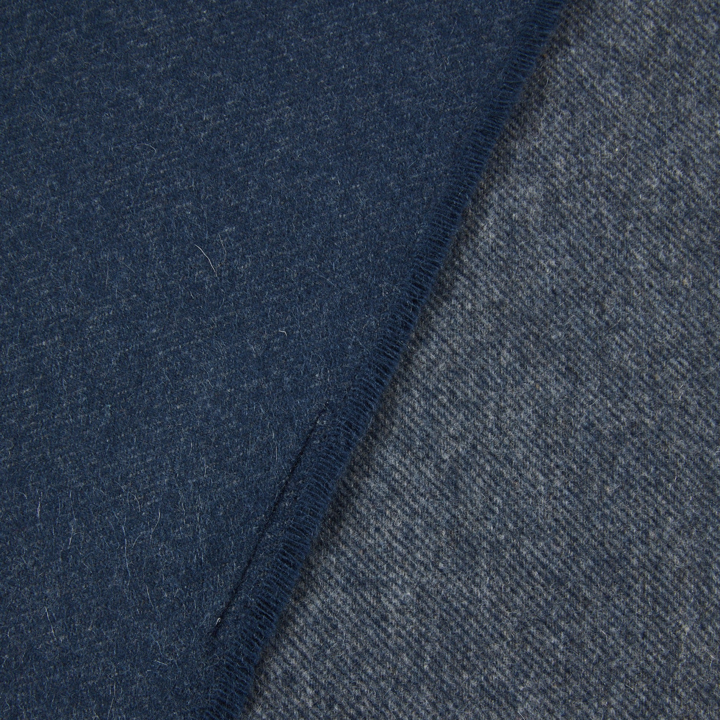 Close-up of Lanerossi Everest Colour throw folded edge, showing navy and slate reverse.
