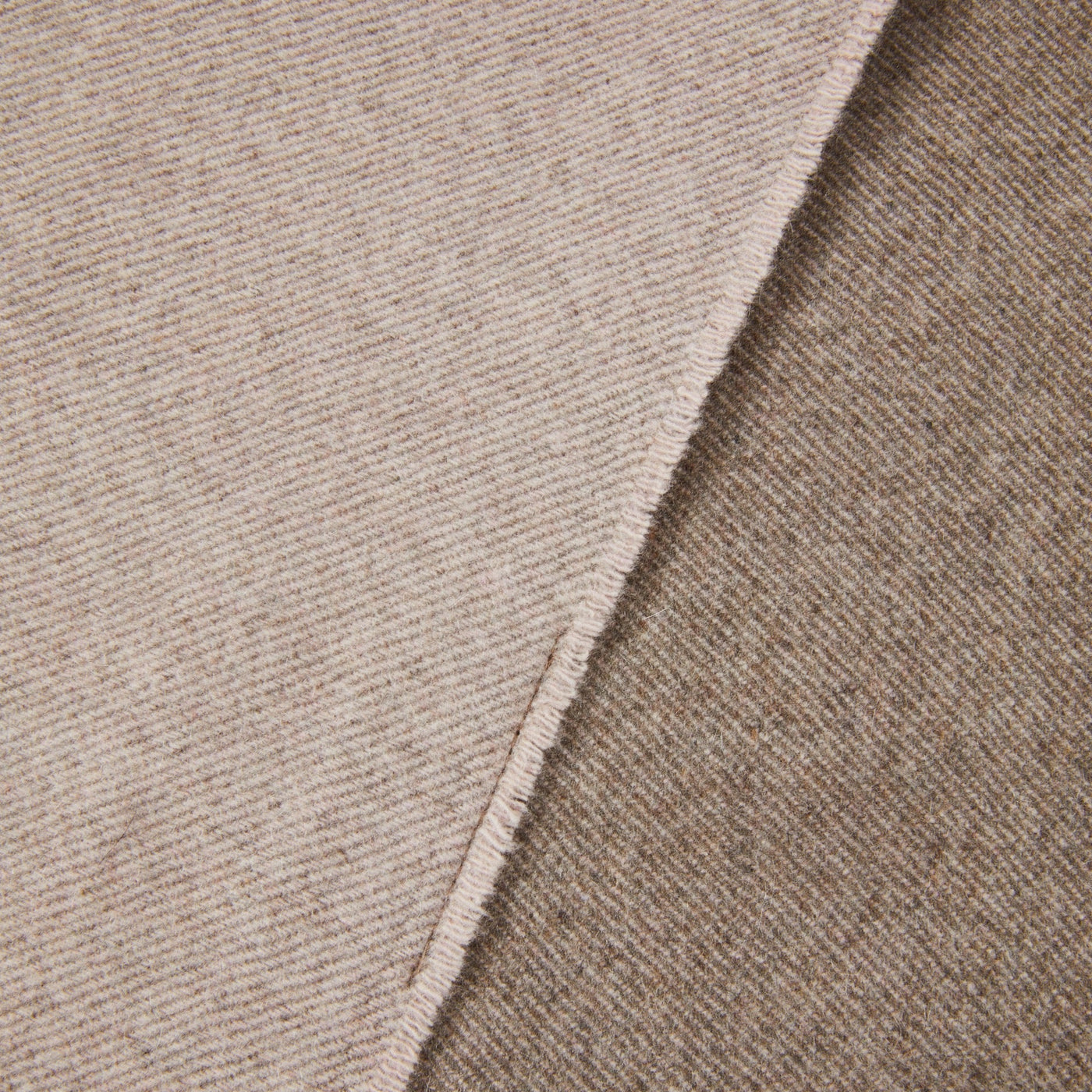 Close-up of Lanerossi Everest Colour throw hem, showing oatmeal diagonal twill weave and folded edge detail.