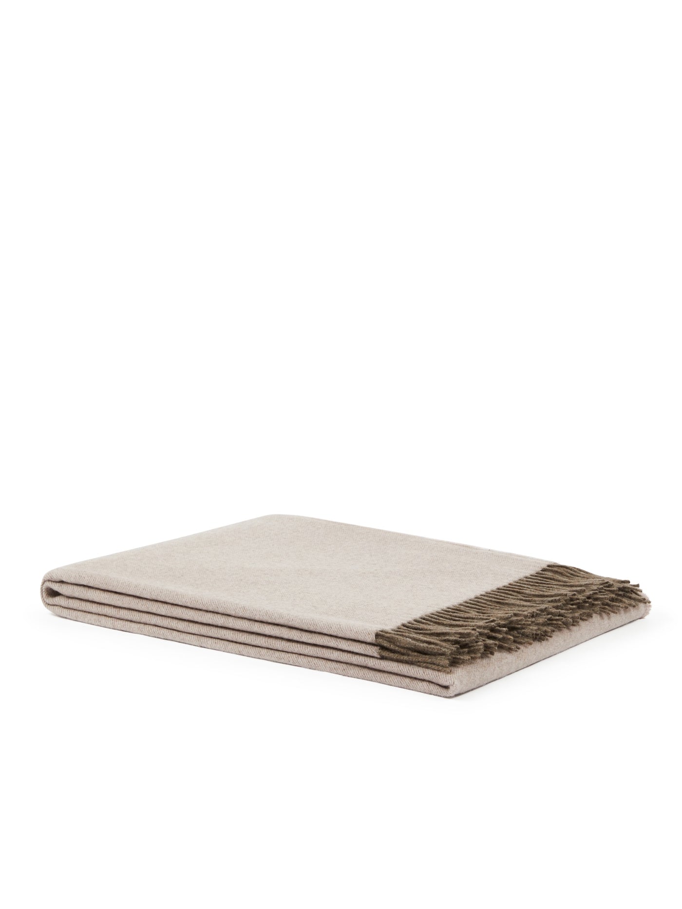 Folded ivory throw with taupe fringe trim, showing layered edge detail.