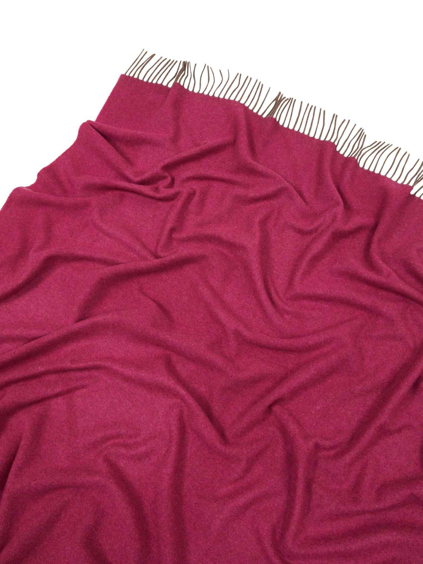 Raspberry throw draped to show soft fabric drape and fringe trim detail.