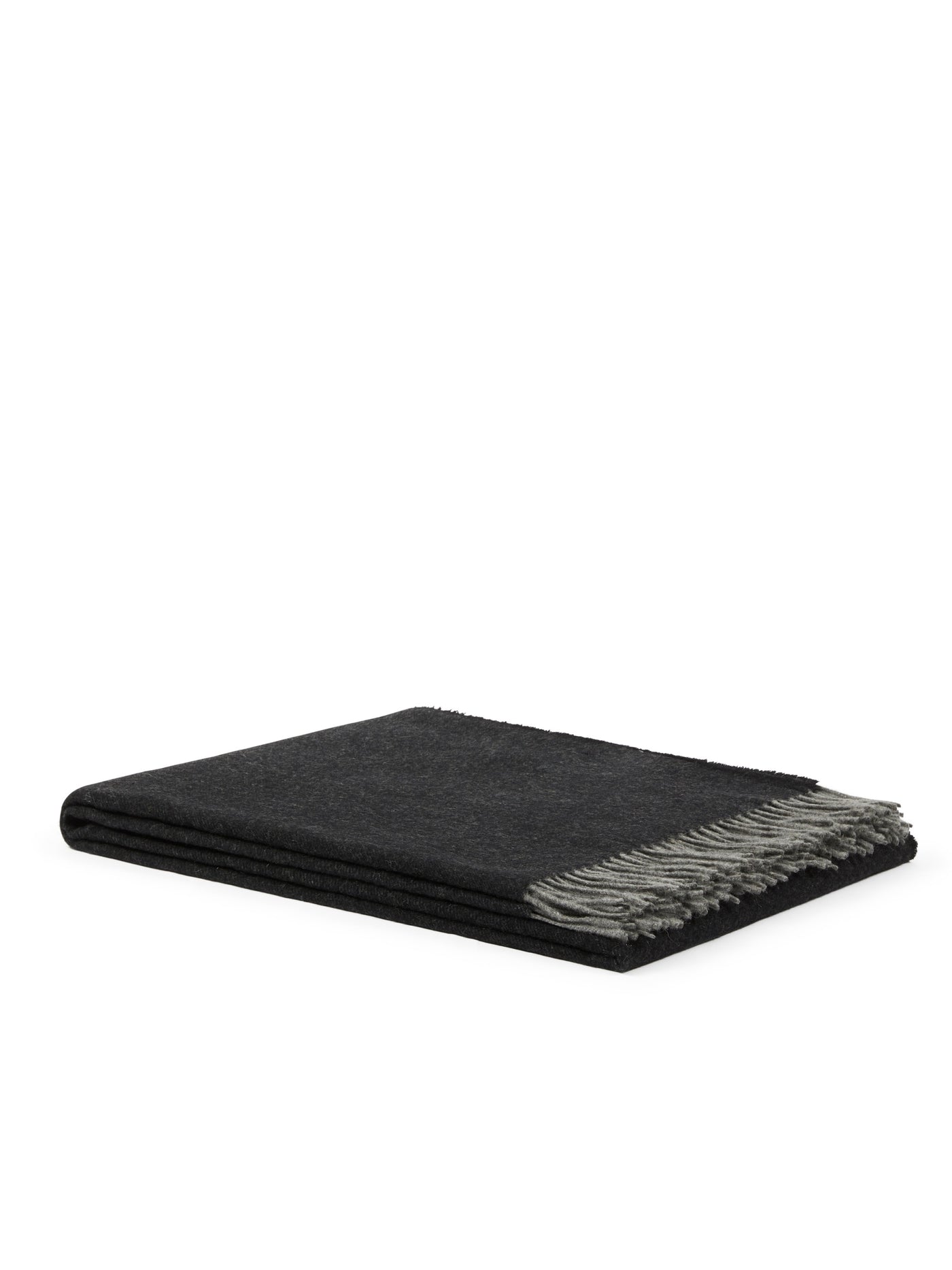 Folded charcoal wool throw with contrast grey fringe trim, side angle view.