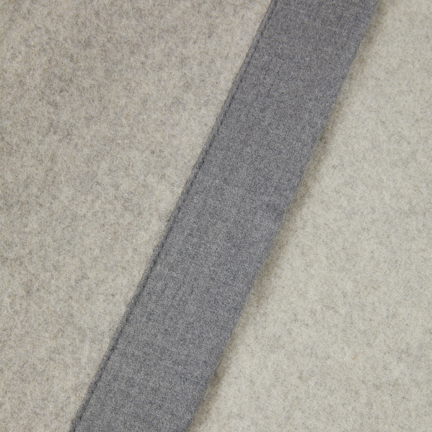 Close-up of Lanerossi Geisha blanket showing grey contrast trim against ivory wool.