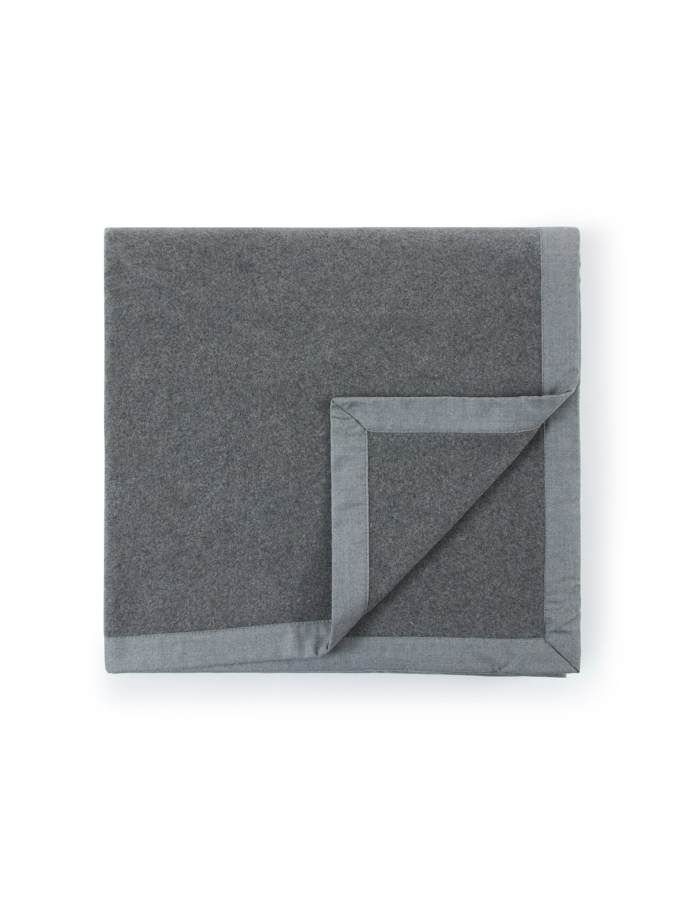 Folded charcoal wool blanket with contrast grey satin binding trim detail.