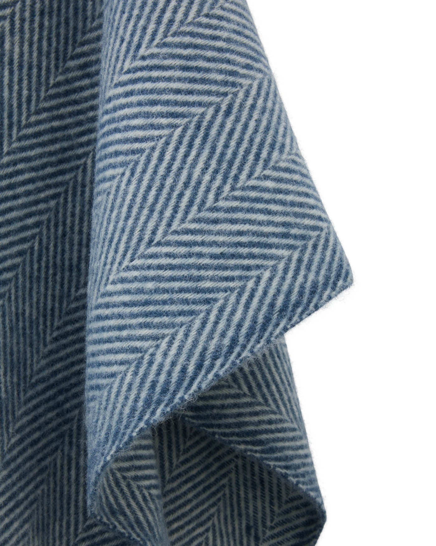 Close-up of Lanerossi Iseo Spina poncho showing navy herringbone weave texture and folded hem.