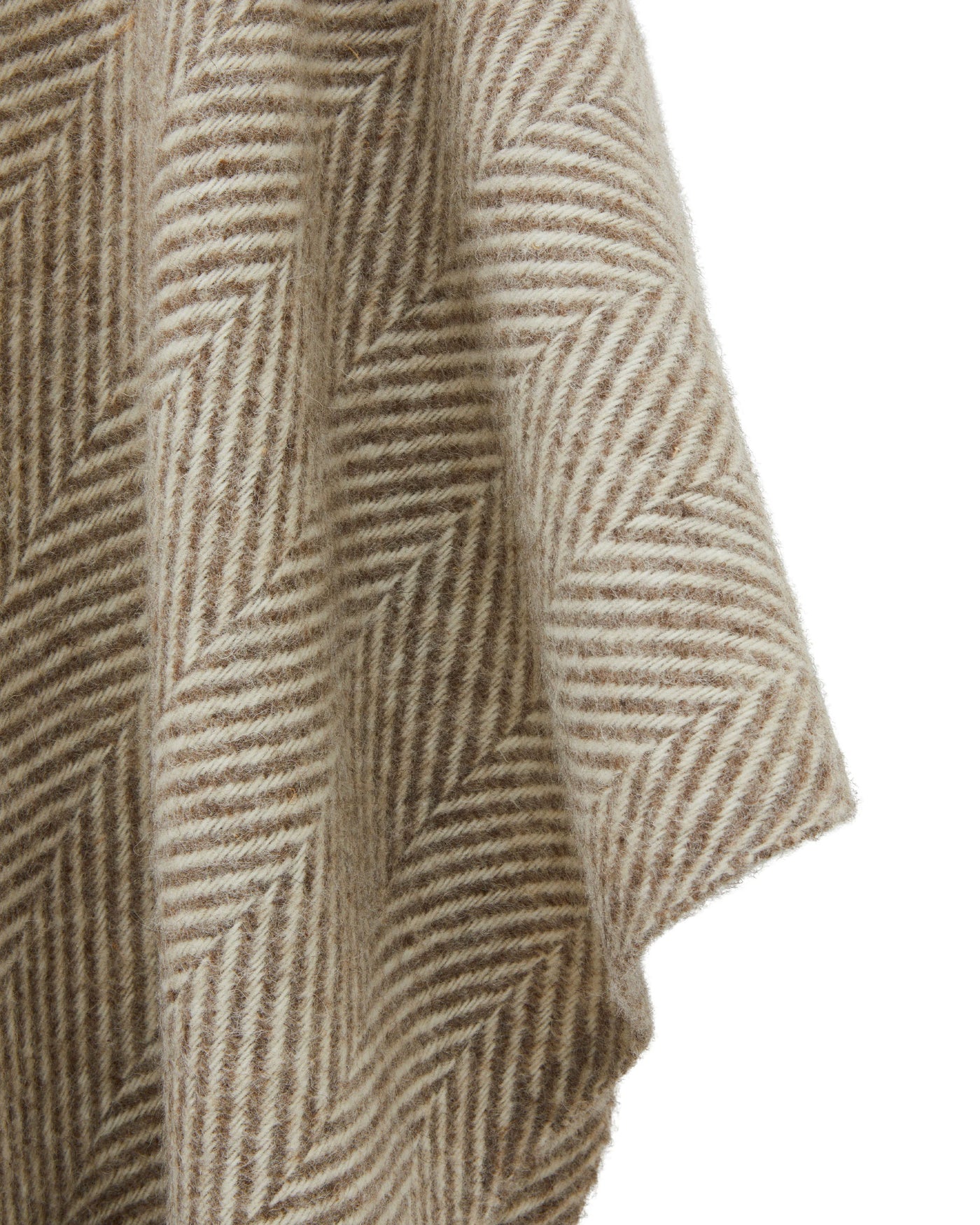 Close-up of Lanerossi Iseo Spina poncho draping, showing taupe herringbone weave texture.