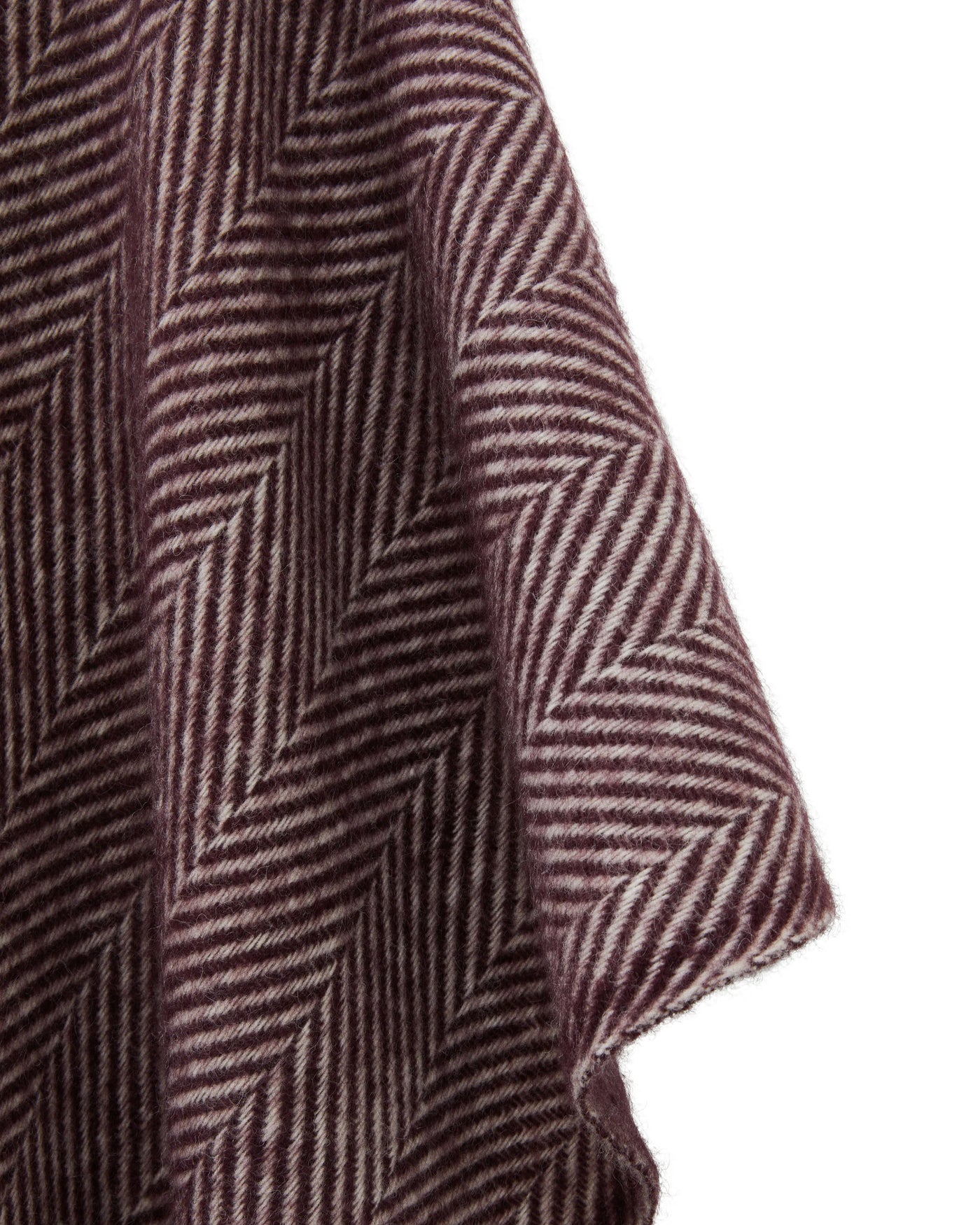Close-up of Lanerossi Iseo Spina poncho drape showing burgundy herringbone weave texture.