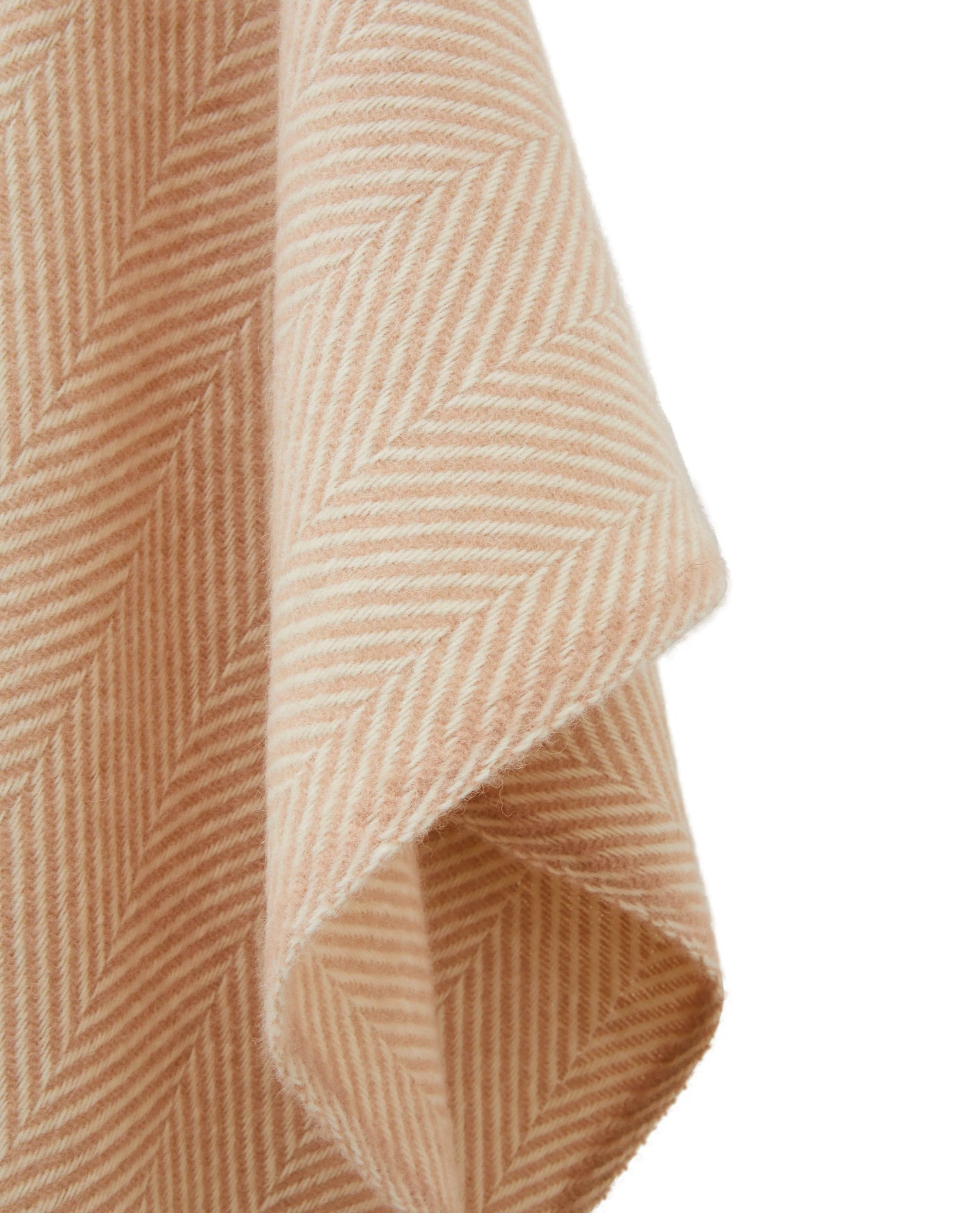 Close-up of blush and ivory herringbone weave fabric, draped corner detail visible.