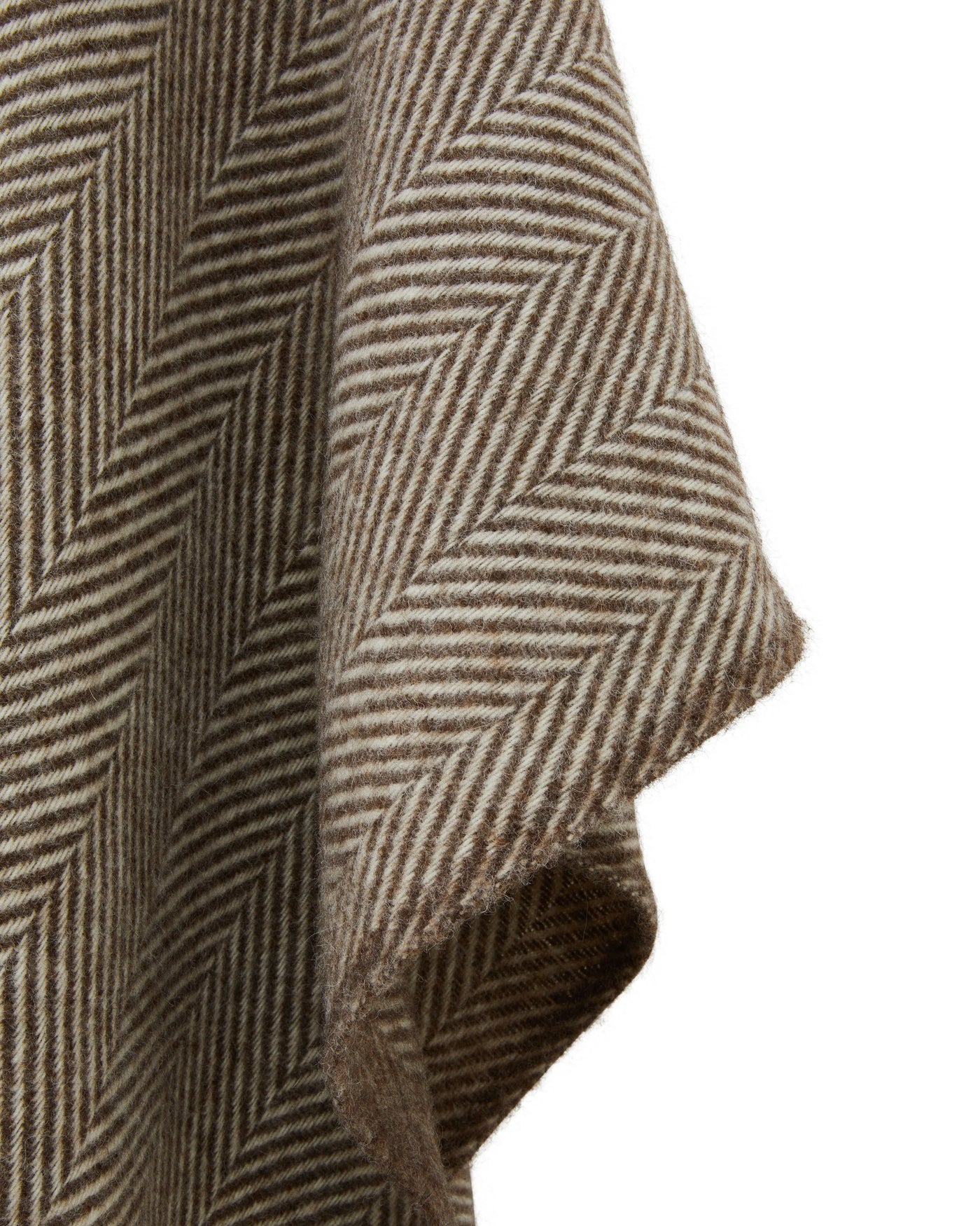 Close-up of Lanerossi Iseo Spina poncho showing taupe herringbone weave and folded hem detail.