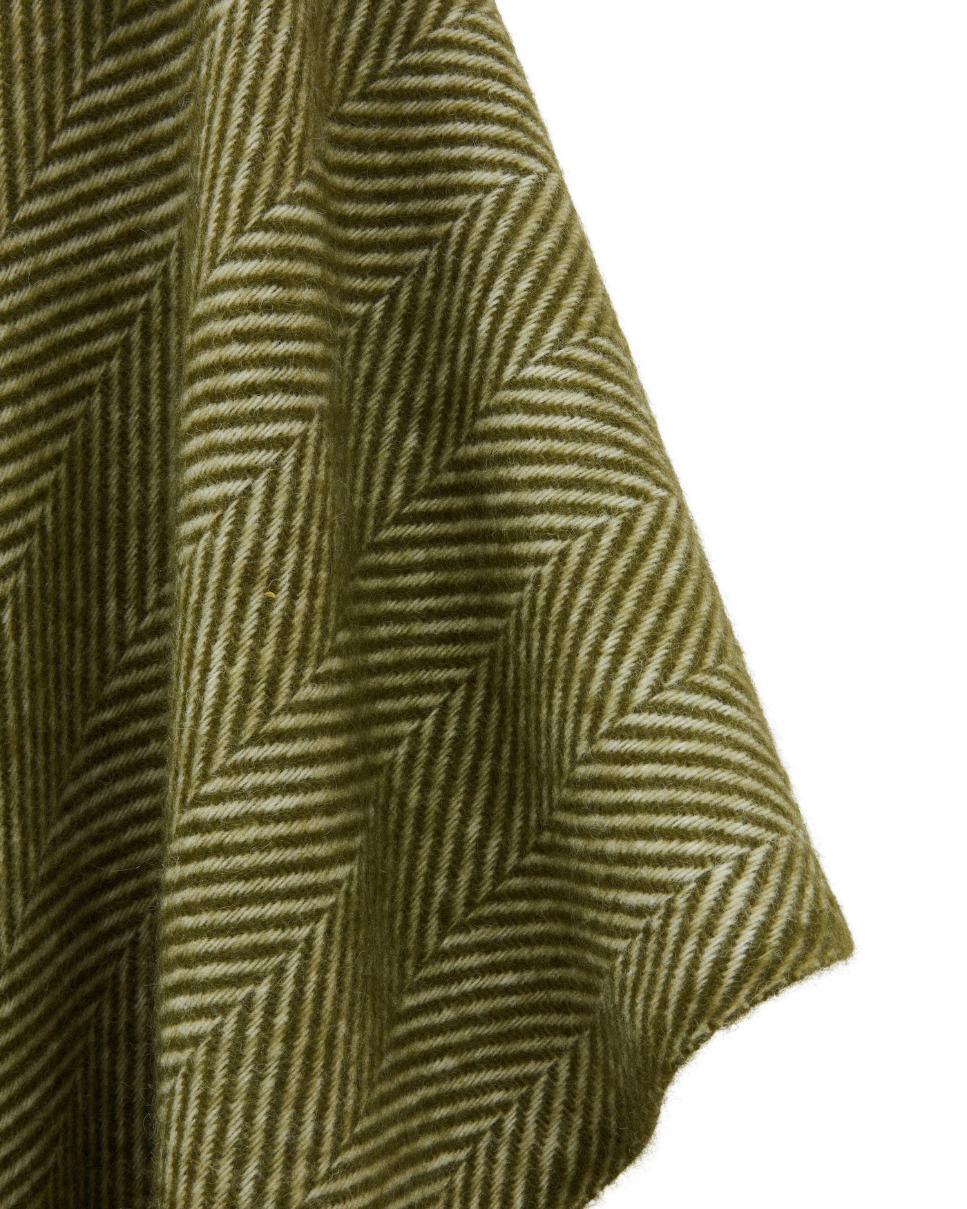 Close-up of olive herringbone weave on Iseo Spina poncho, showing draped wool fabric texture.