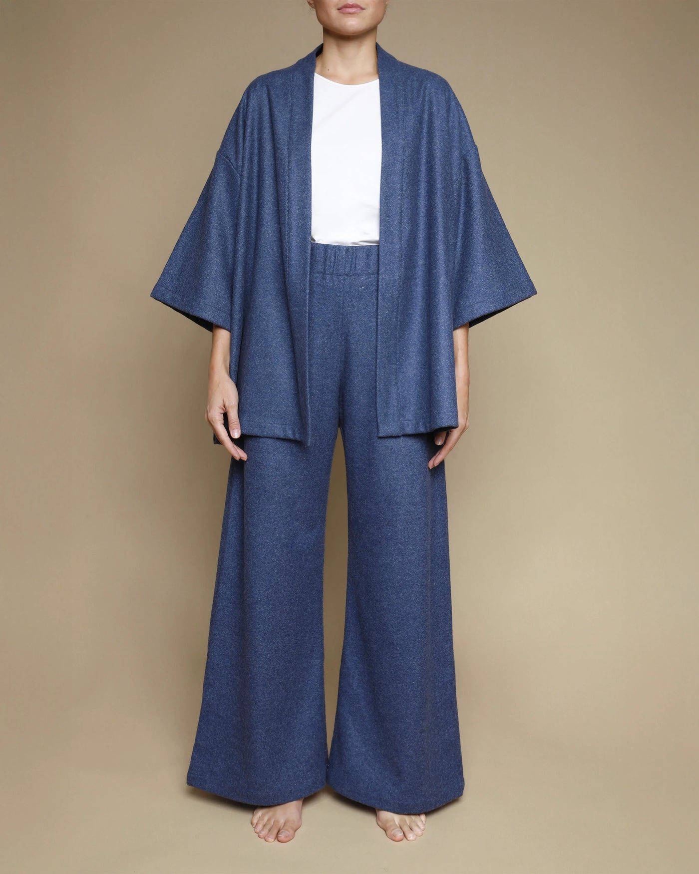 Lanerossi Extrafine Merino kimono jacket in denim blue, styled with matching wide-leg trousers.