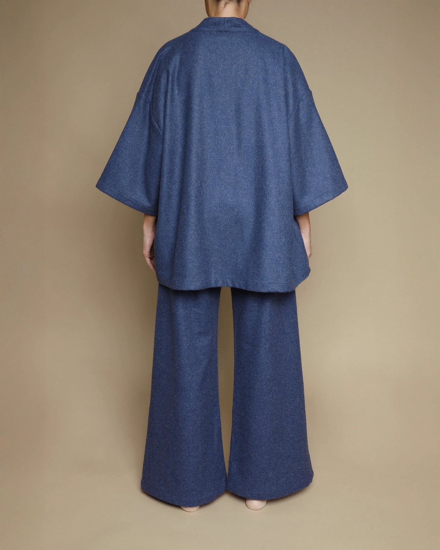 Back view of Lanerossi Extrafine Merino Kimono Jacket in indigo, styled with matching wide-leg trousers.