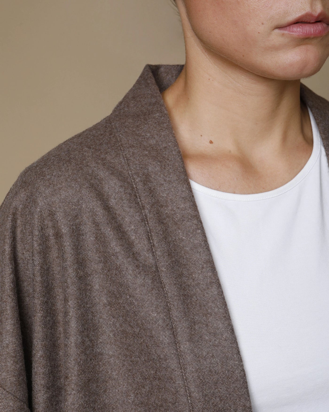 Close-up of Lanerossi Extrafine Merino Kimono Jacket lapel in taupe, draped open over white tee.