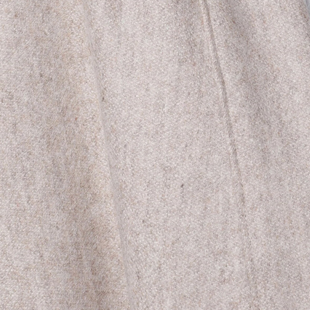 Close-up of Lanerossi extrafine merino fabric in oatmeal, showing soft drape and seam detail.