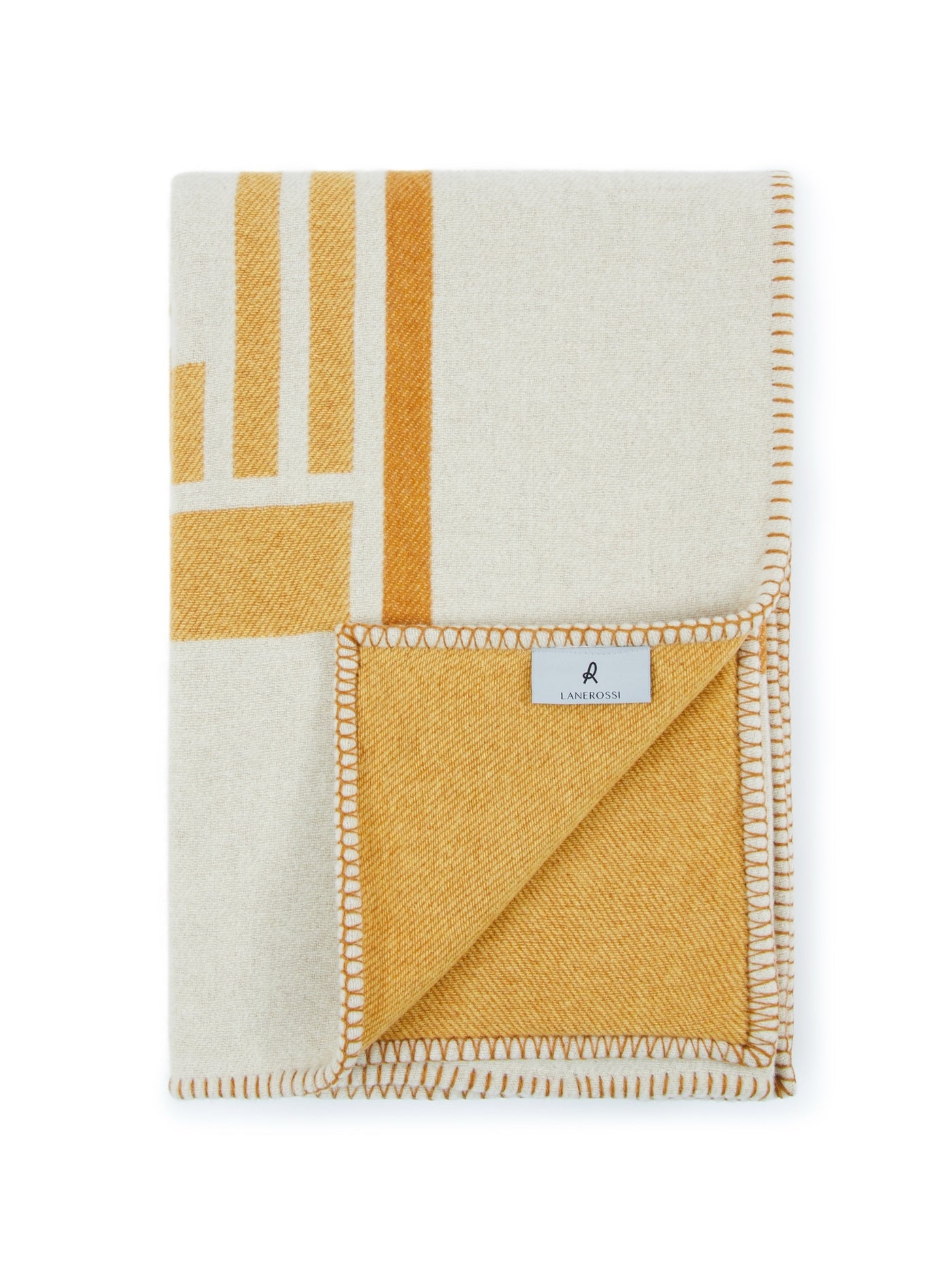 Lanerossi Metropolis throw in ivory and amber, folded to show geometric pattern and blanket-stitched edge.