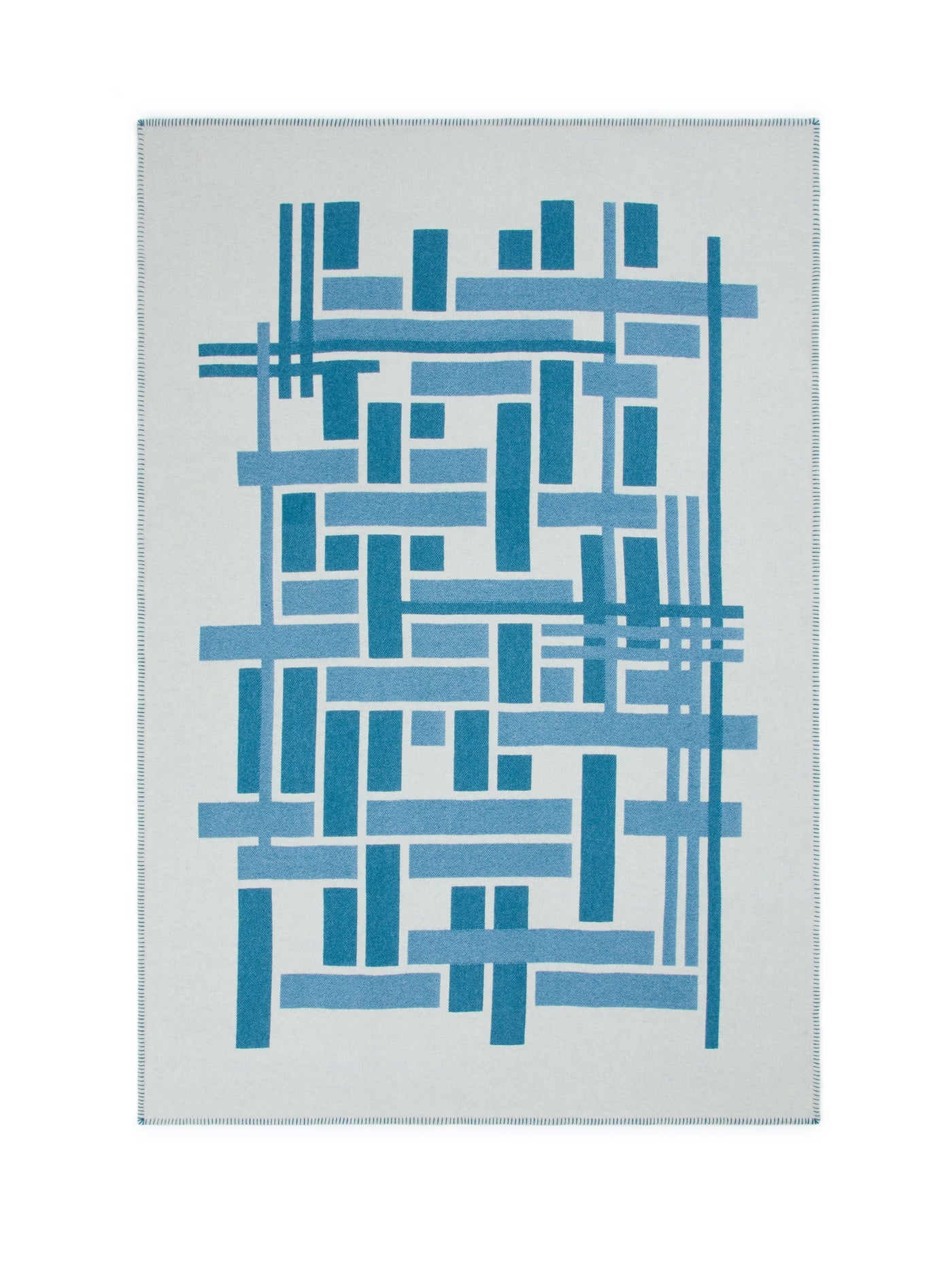 Close-up of Metropolis throw's geometric grid pattern in teal and sky blue on ivory.
