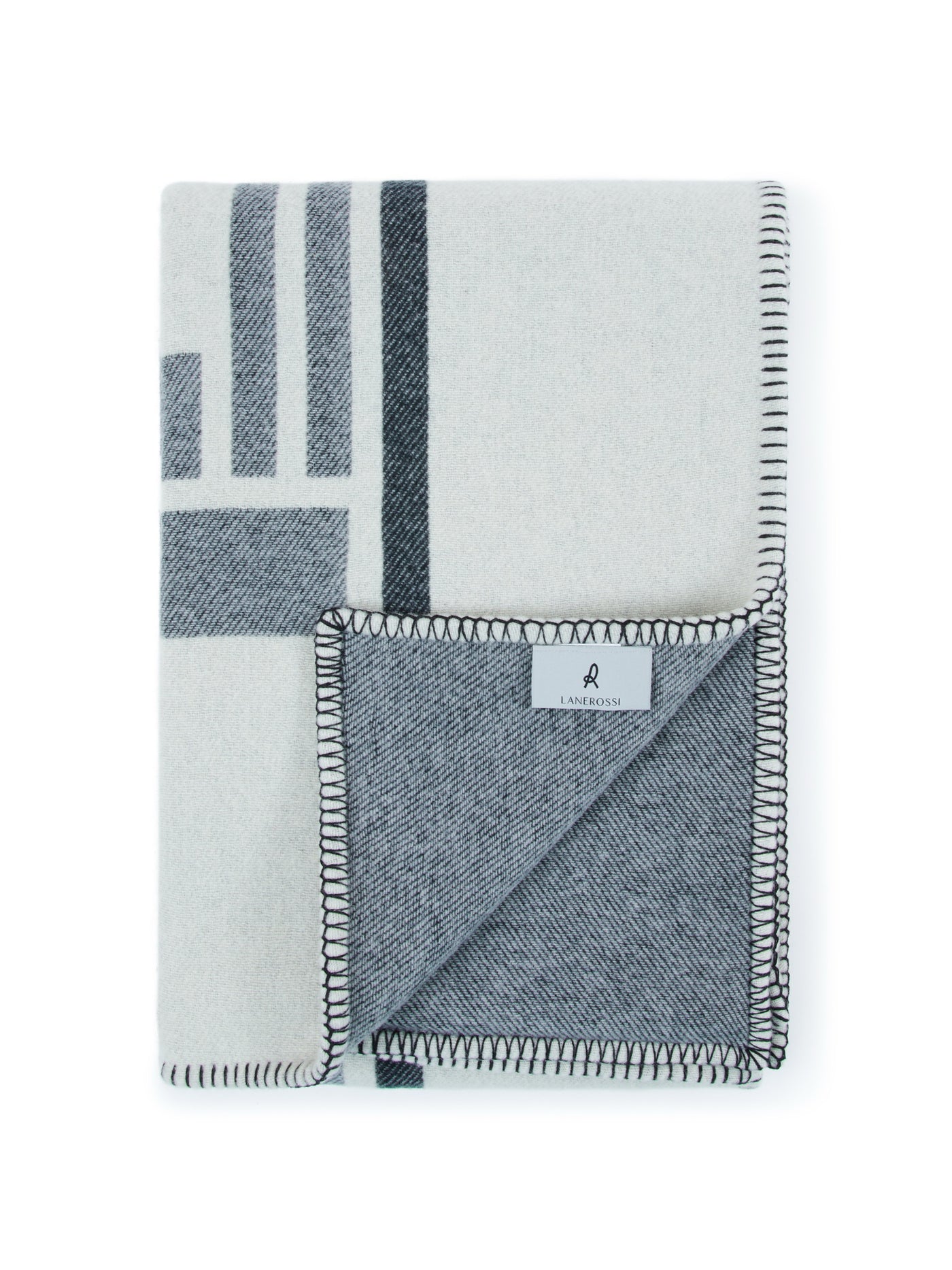 Folded Lanerossi Metropolis throw showing charcoal blanket stitch edge and woven label detail.