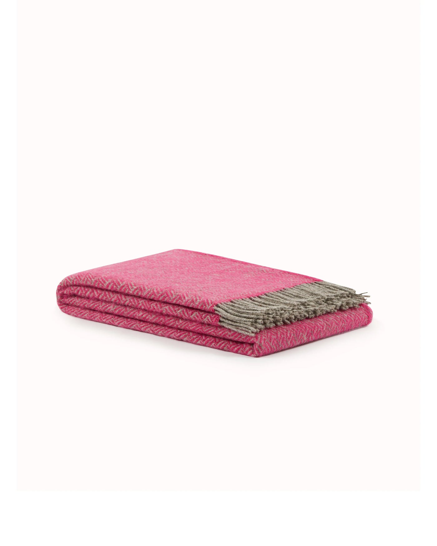Lanerossi Mata Mata throw folded flat, raspberry herringbone weave with taupe fringe trim.