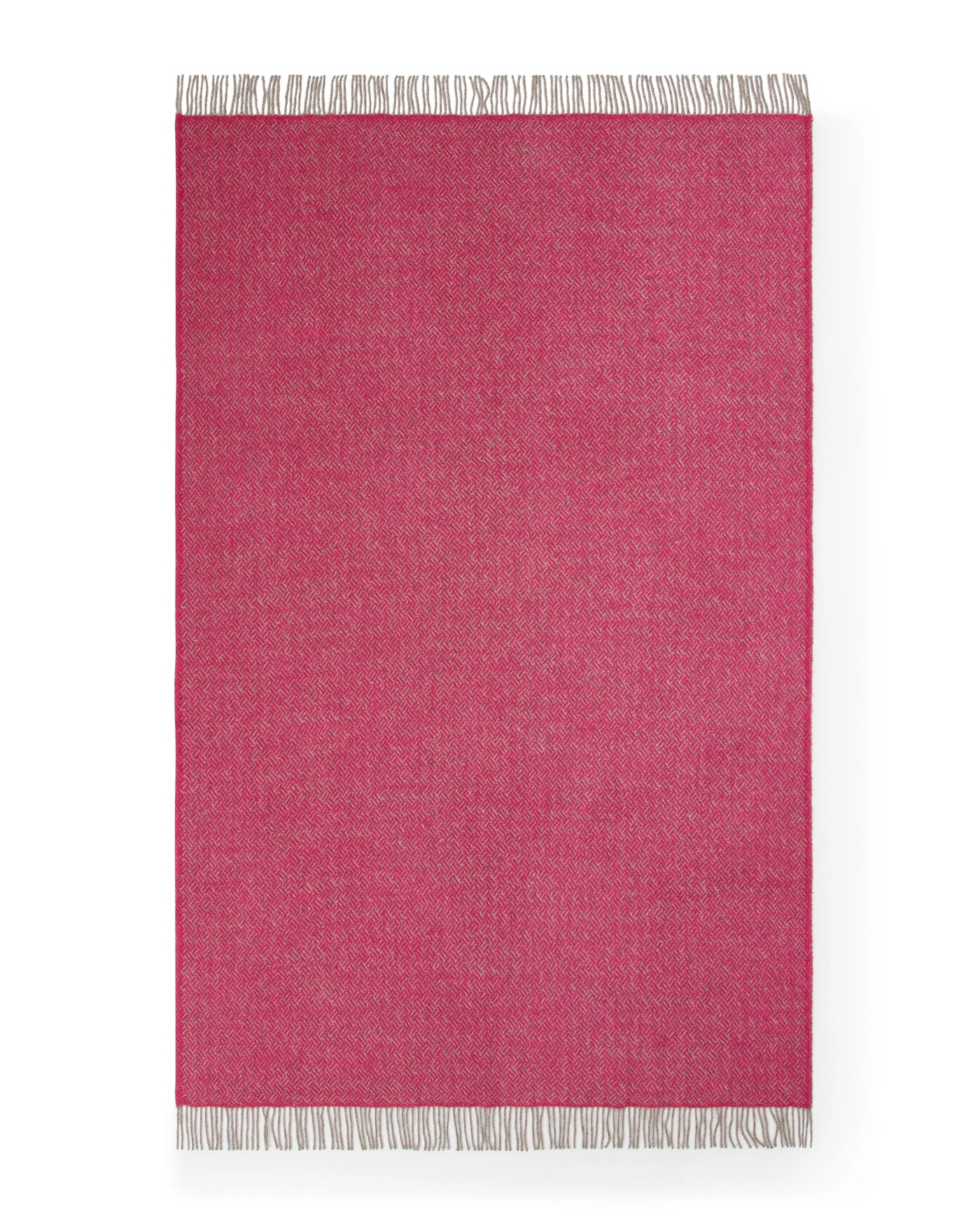 Lanerossi Mata Mata throw in raspberry with contrast fringe trim, flat lay view.